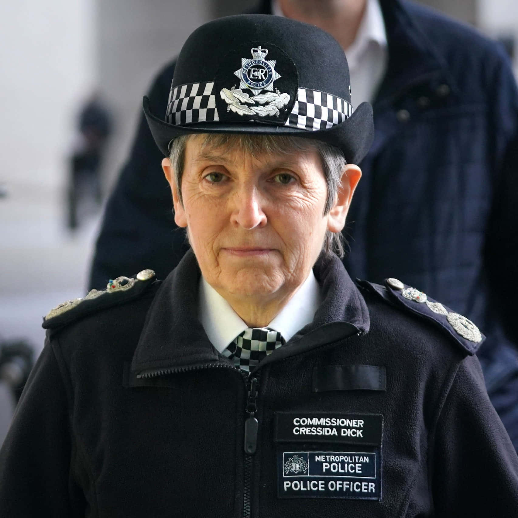 A Woman In A Police Uniform Standing Outside Wallpaper