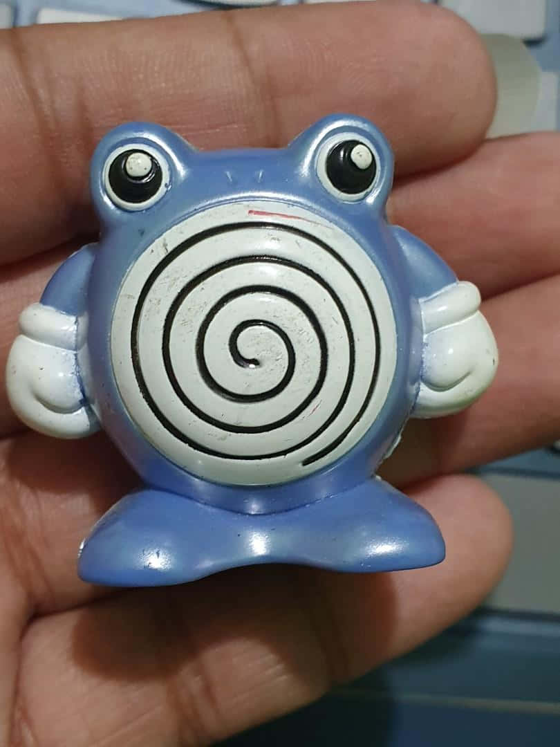 Poliwhirl Figure In Hand Wallpaper
