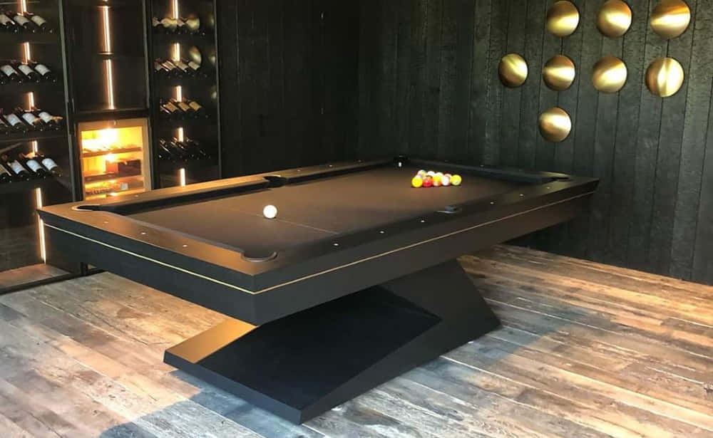 A Pool Table With A Black Leather Top And Gold Trim