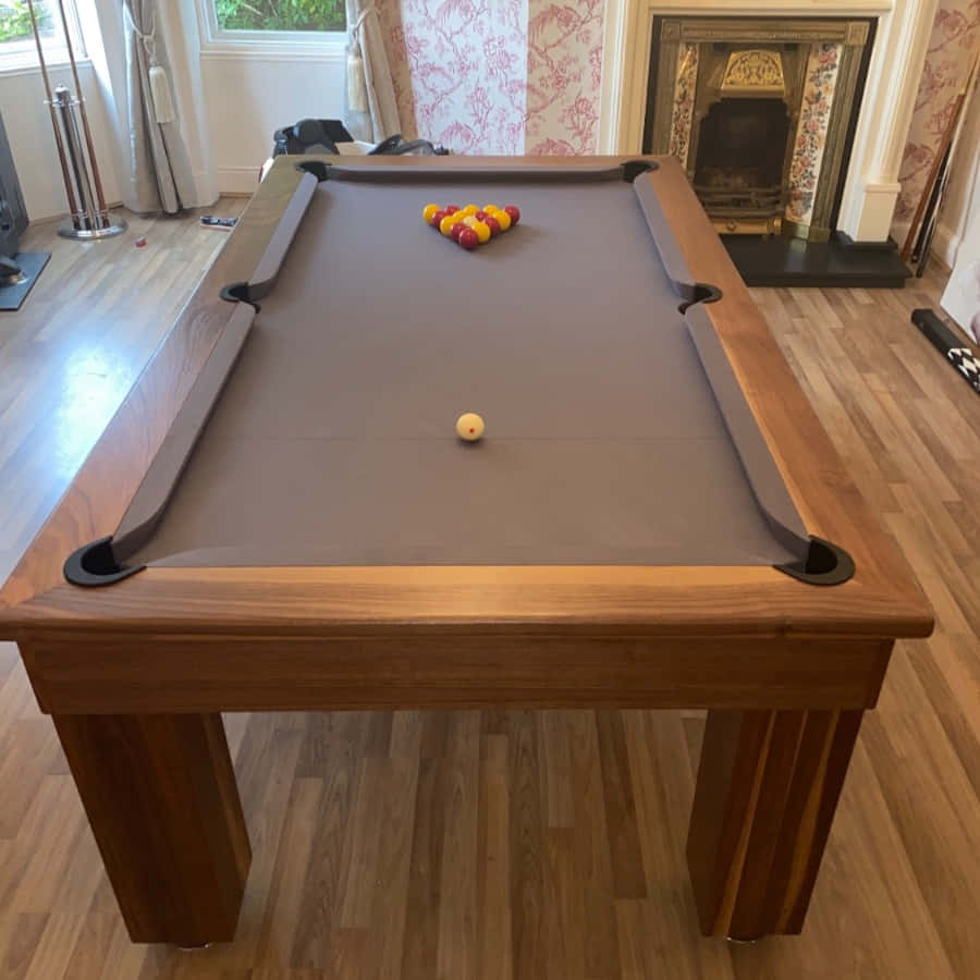 A Pool Table With A Grey Cloth And Balls