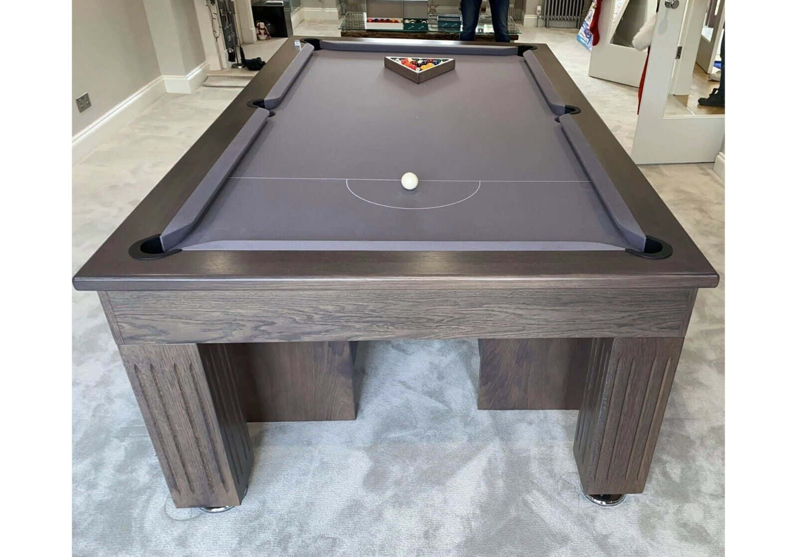 A Pool Table With A Grey Cloth And A Black Ball