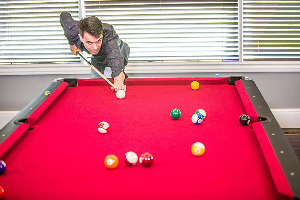 A classic pool table and billiard balls, ready for a game of 8 ball