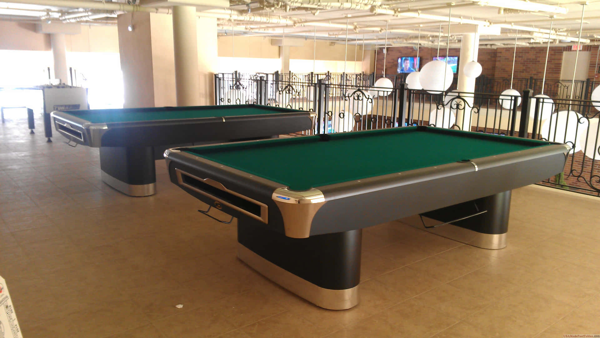 Two Pool Tables In A Room