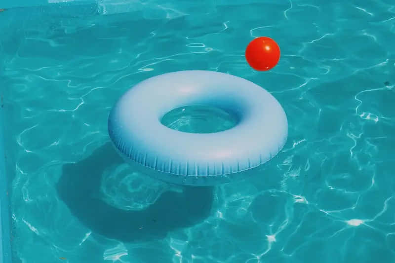 Pool Water Ring And Ball Floater Wallpaper