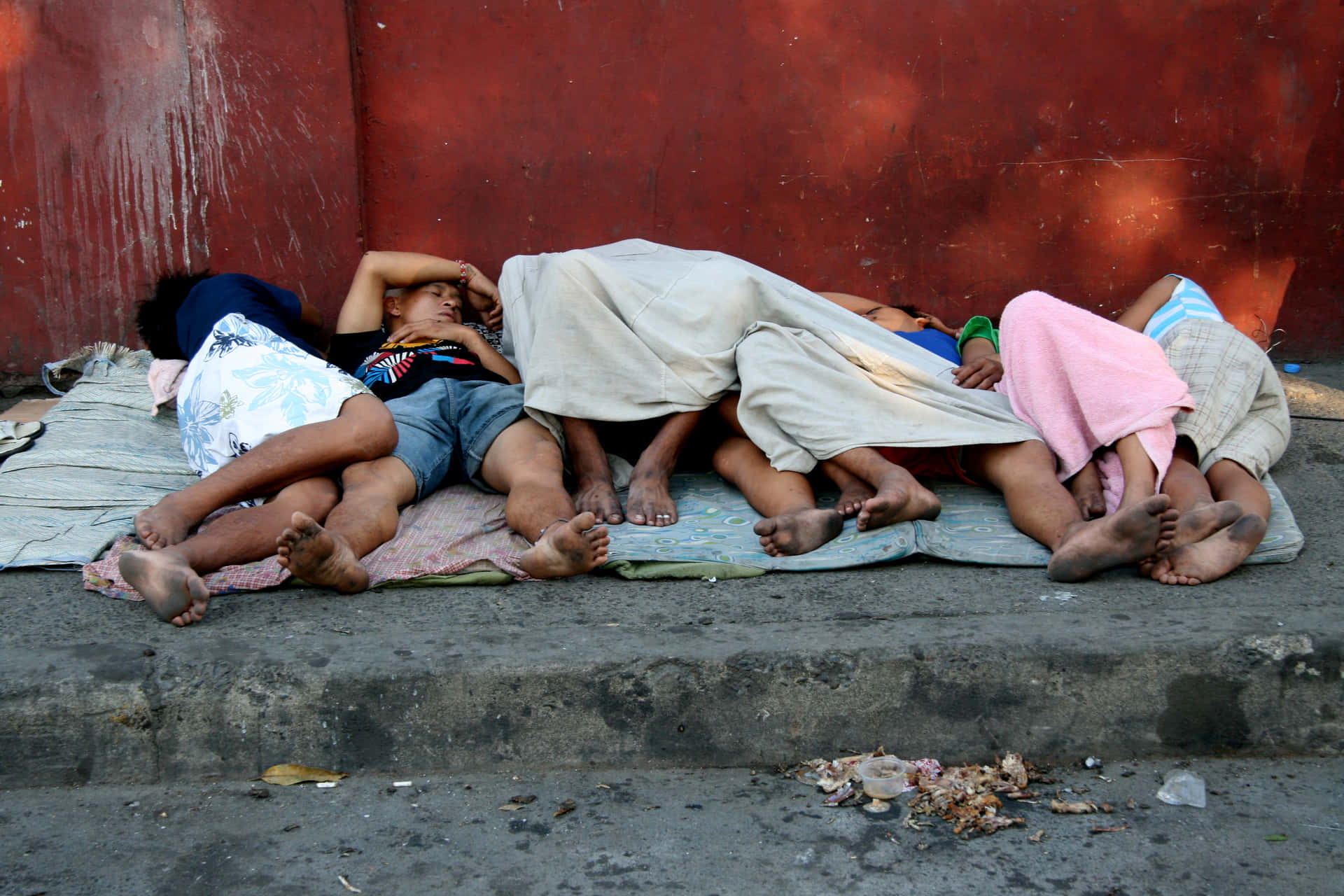 Poor Family Sleeping Beside The Street Wallpaper