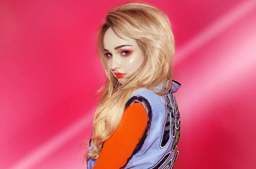 Pop Artist Against Pink Backdrop Wallpaper