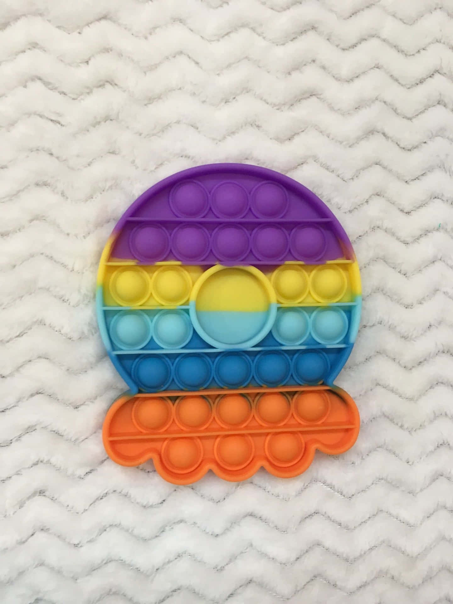 A Colorful Plastic Sphere With A Rainbow Colored Ring