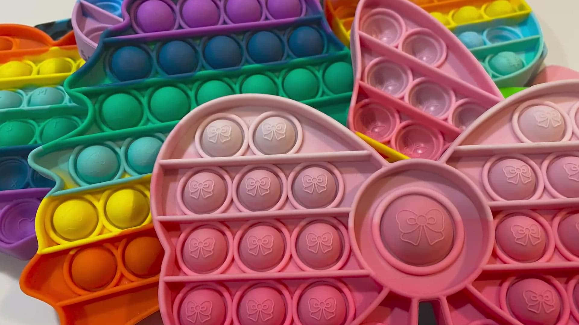 A Tray Of Colorful Eggs With A Bow On Top