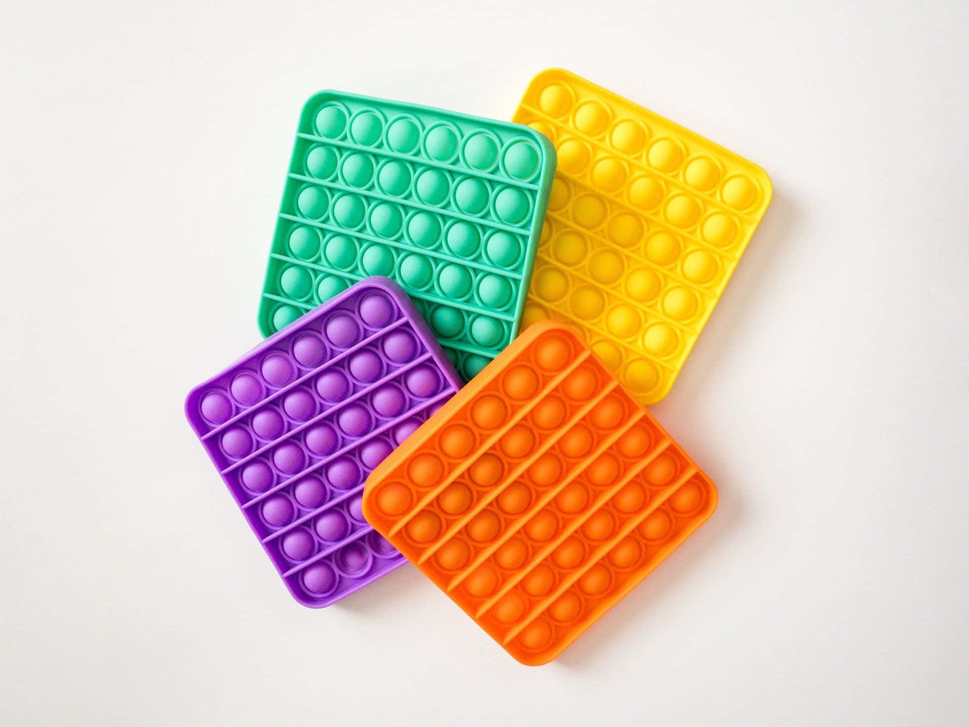 Four Plastic Ice Cube Trays With Different Colors