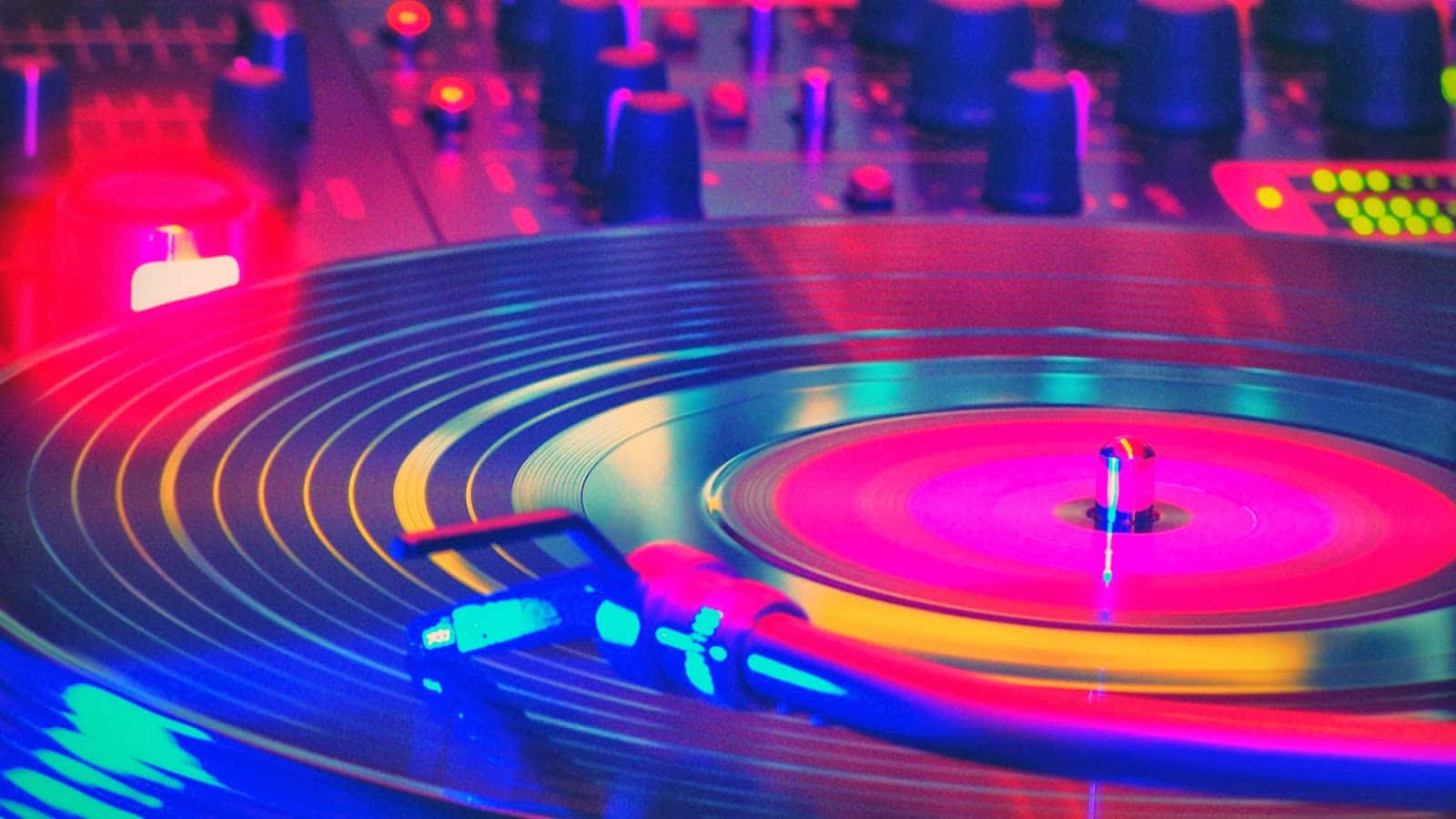 A Dj Turntable With Colorful Lights On It Wallpaper