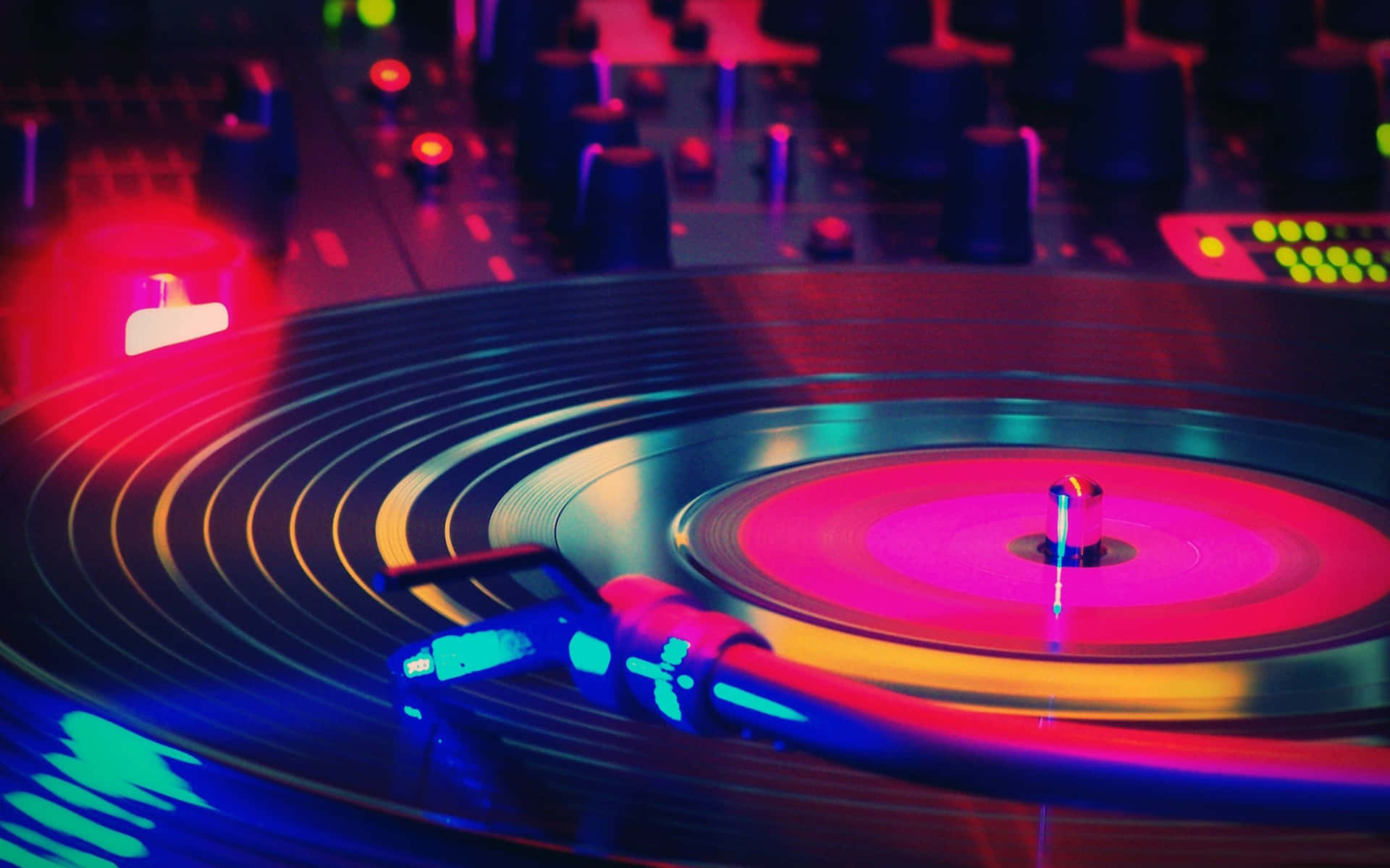 A Dj Turntable With Colorful Lights On It Wallpaper