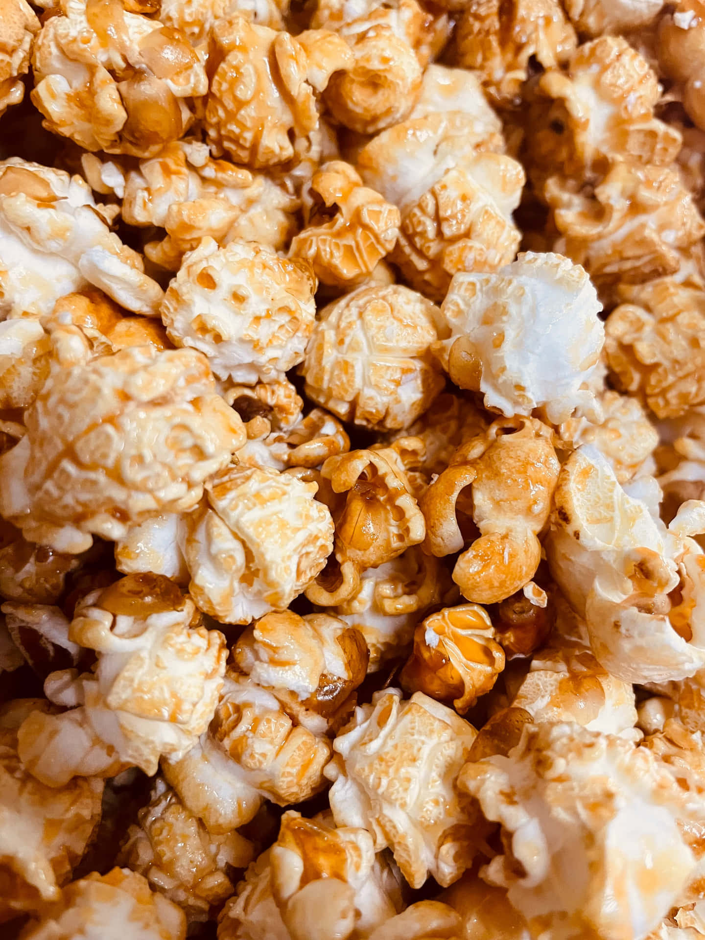 A Bowl Of Popcorn With Caramel