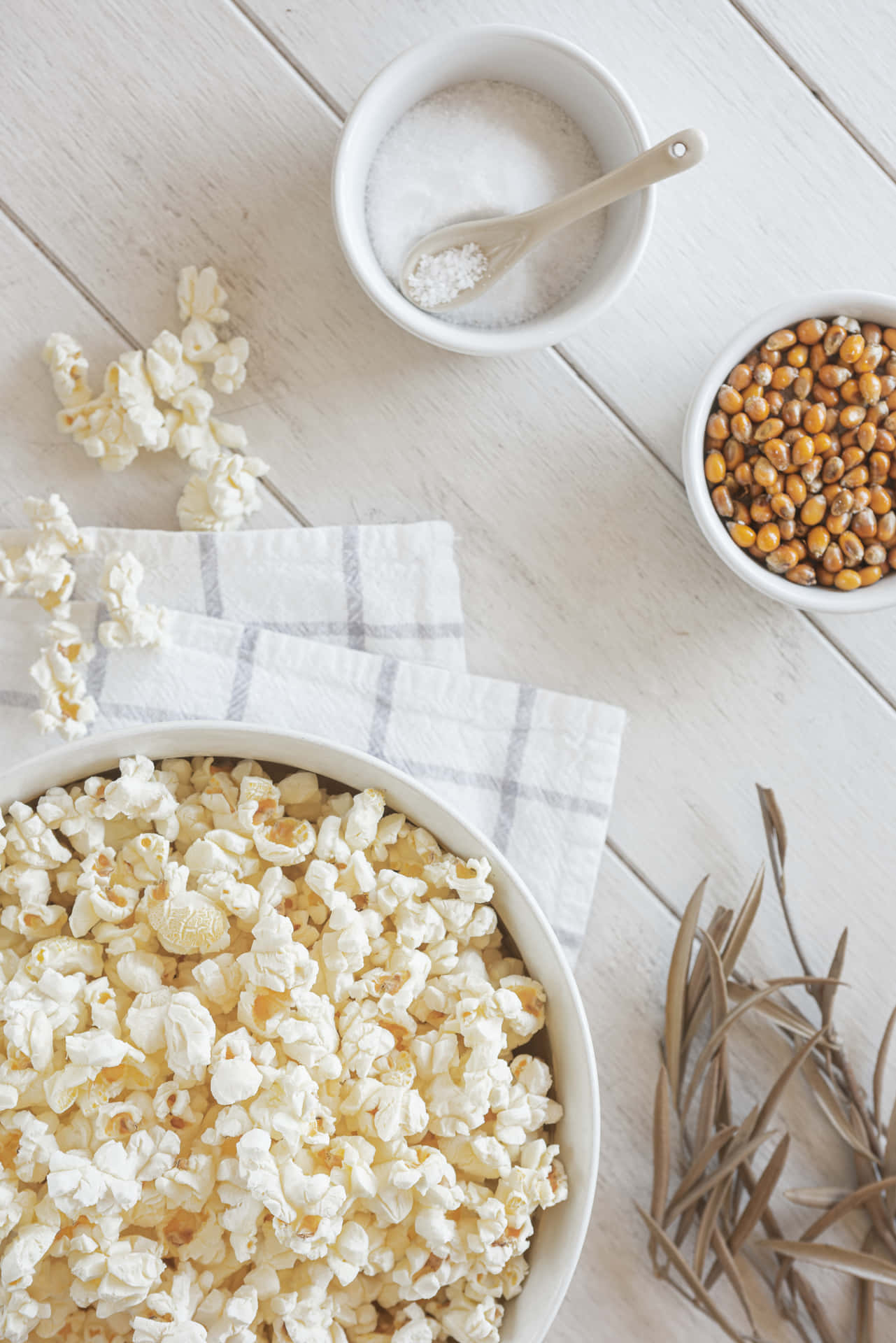 A Bowl Of Popcorn On A White Table