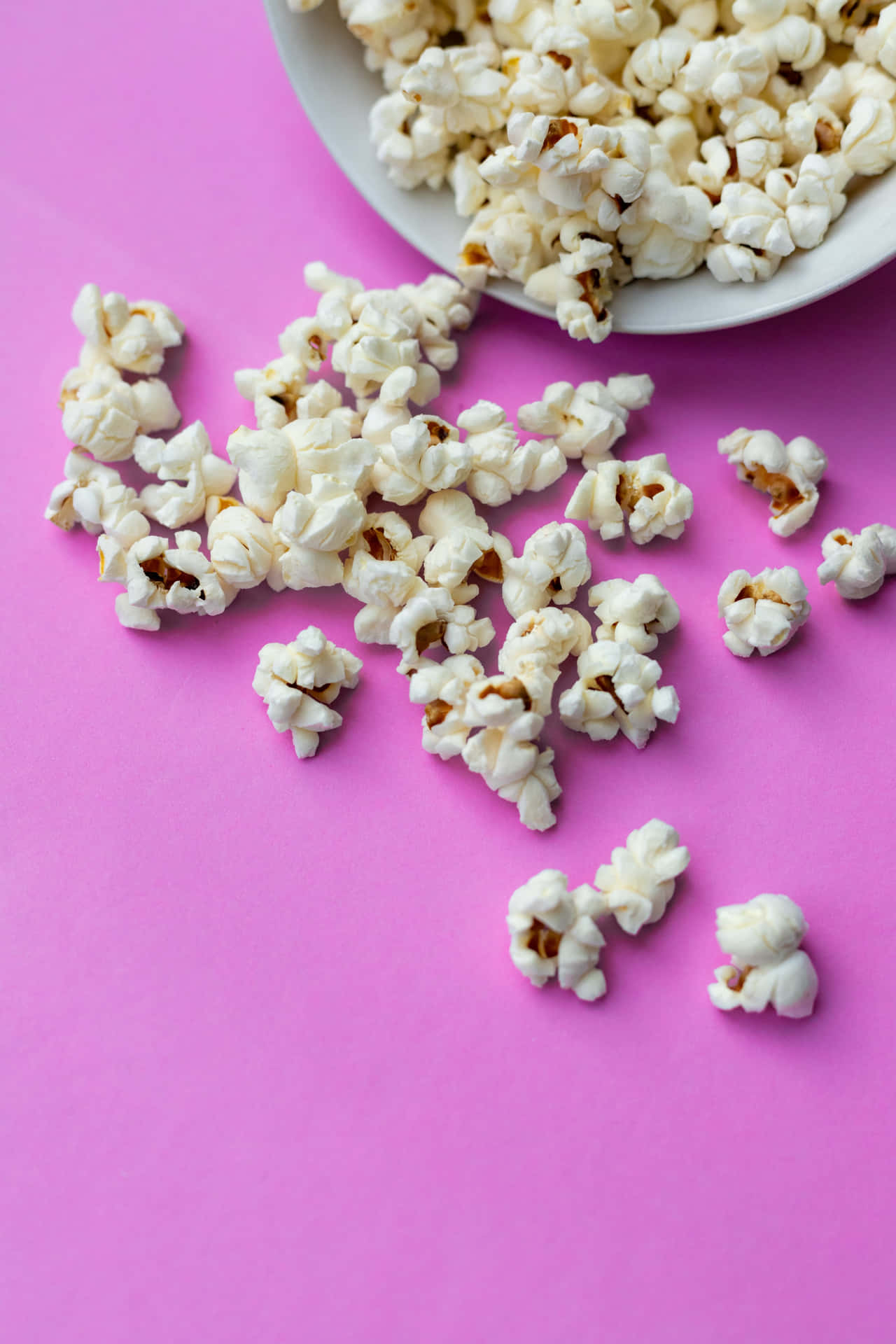 A bucket of fresh and inviting popcorn.