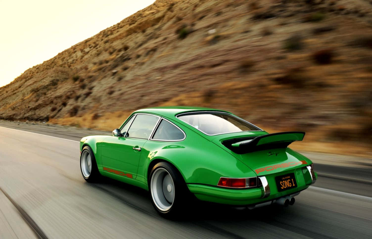 Sleek Porsche Speeding on a Picturesque Road