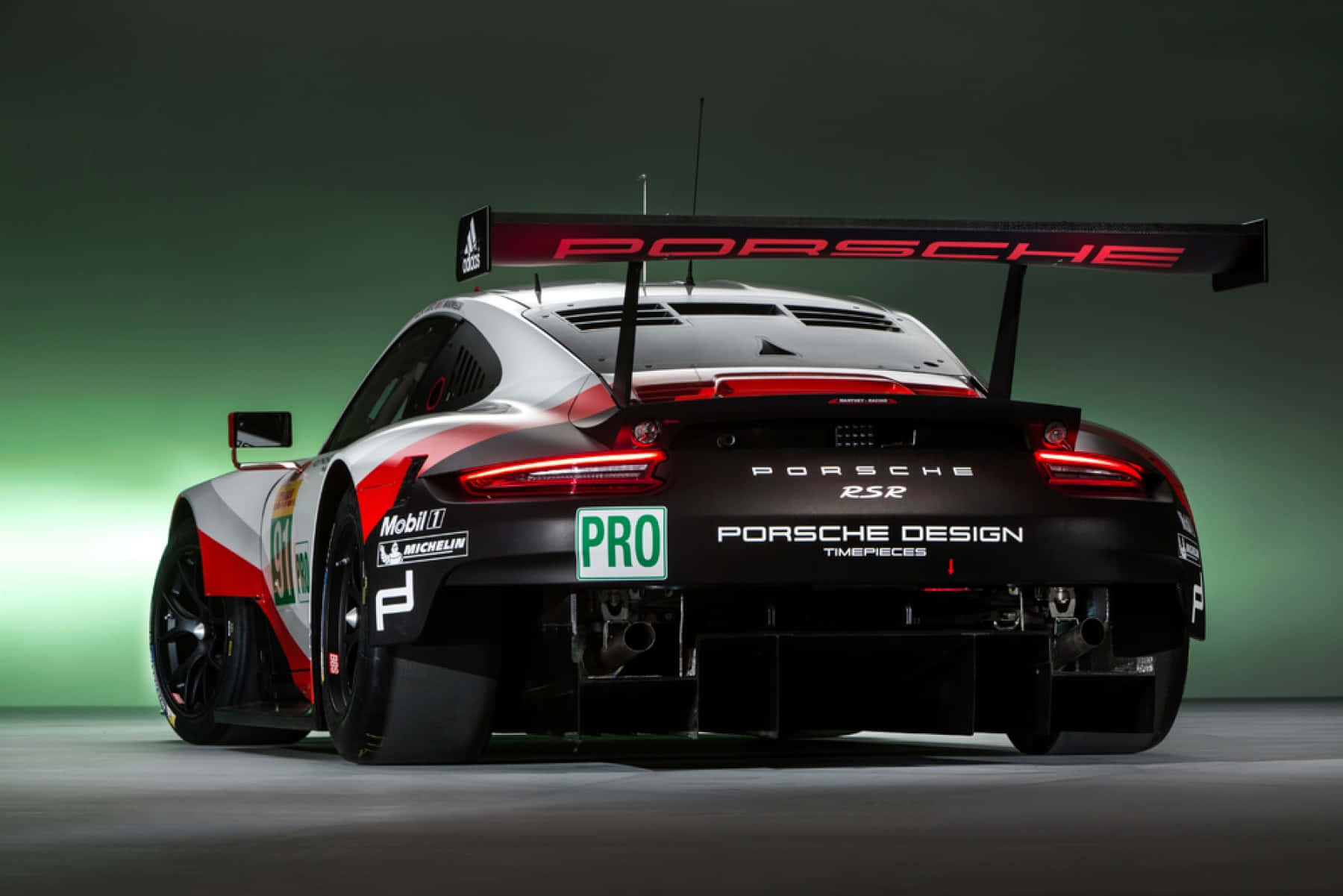 Caption: Sleek Porsche Luxury Sports Car on Open Road