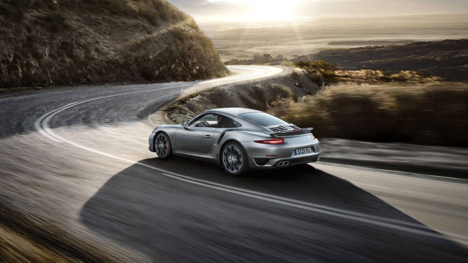 Luxurious Porsche 911 cruising on the open road Wallpaper
