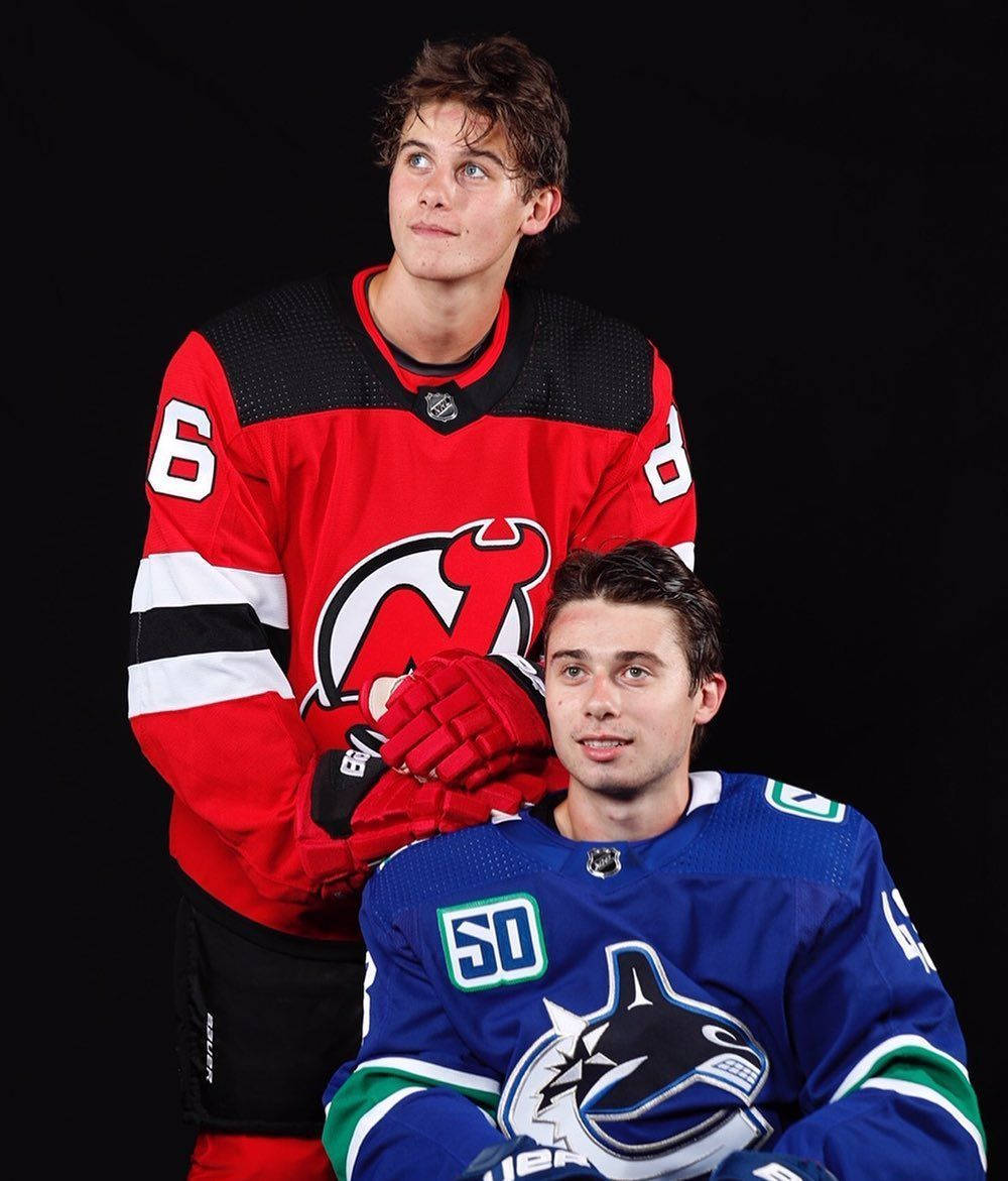 Download Portrait Of Quinn Hughes Posing With Brother Jack Hughes From