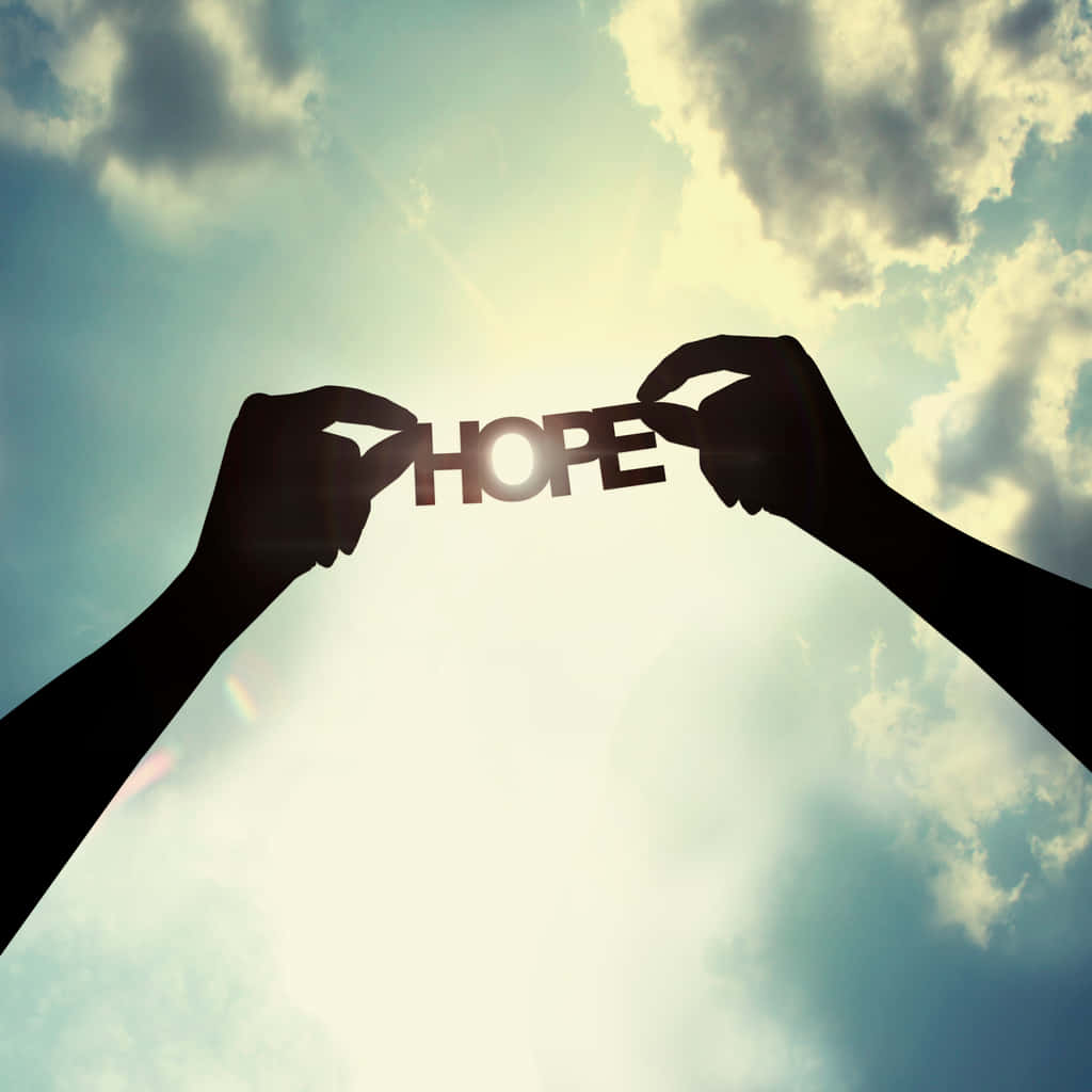 Two Hands Holding Up The Word Hope
