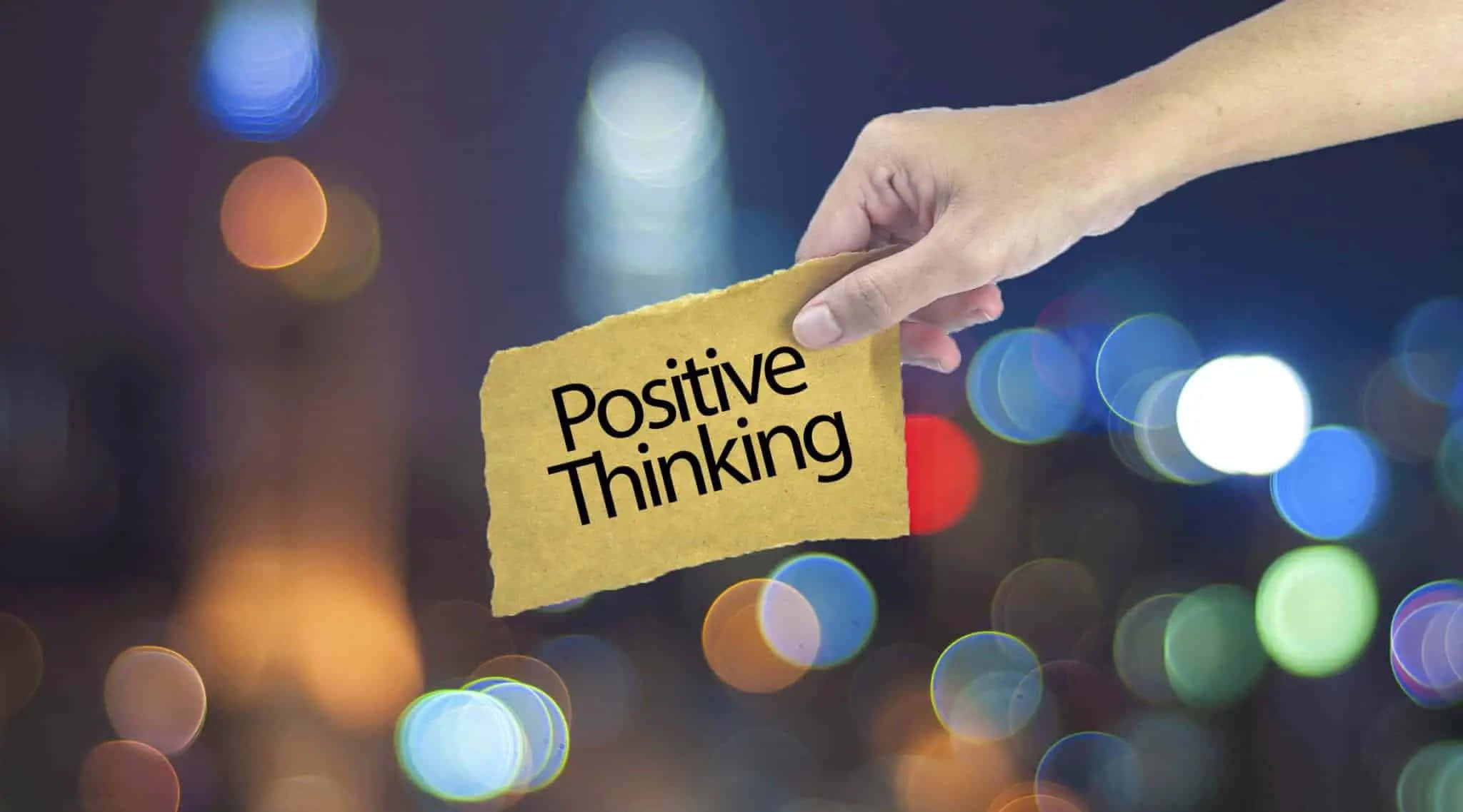 Positive Thinking - A Hand Holding A Piece Of Paper