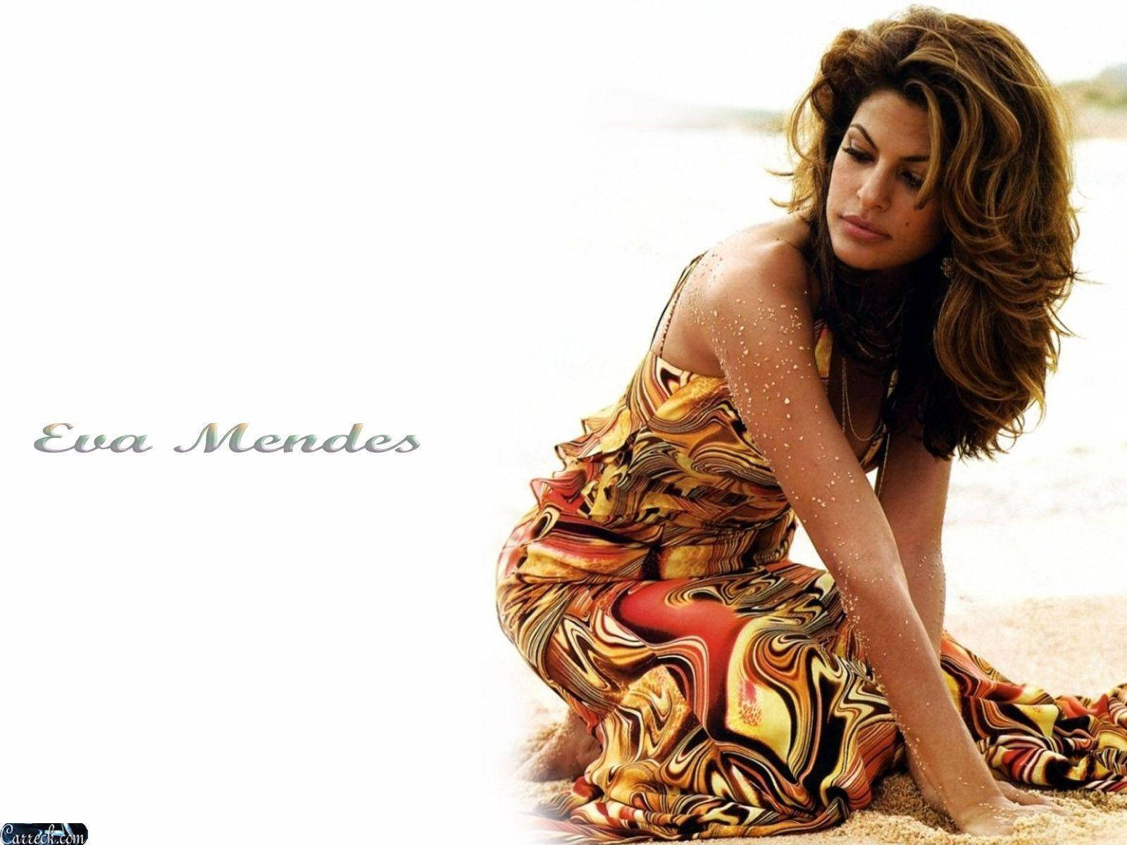 Poster Of Eva Mendes Resting On Sand Wallpaper