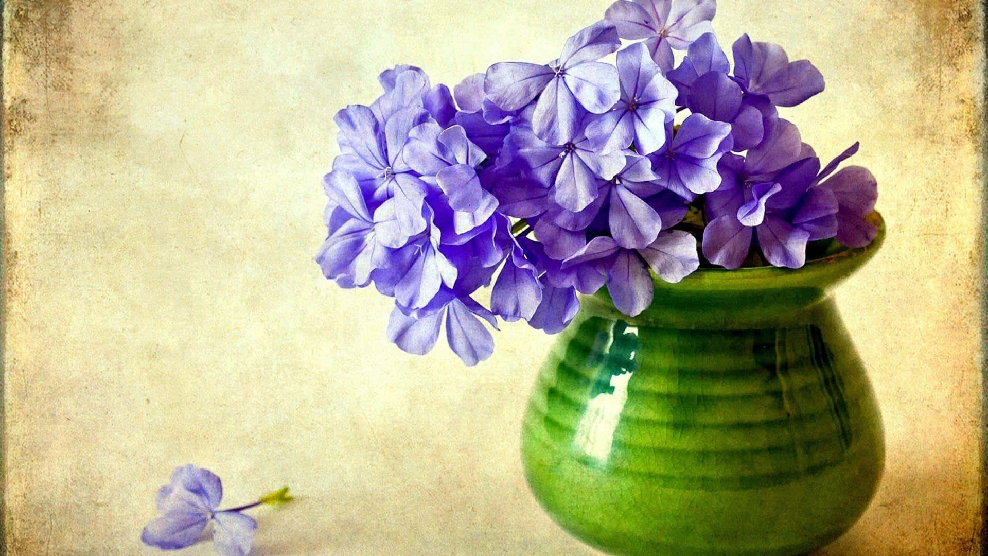 A Green Vase With Purple Flowers