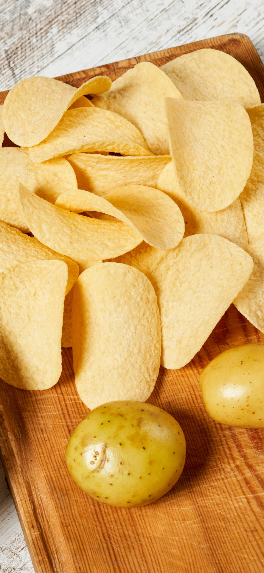 Bright and Crisp iPhone 13 Pro Paired with Delicious Potato Chips Wallpaper