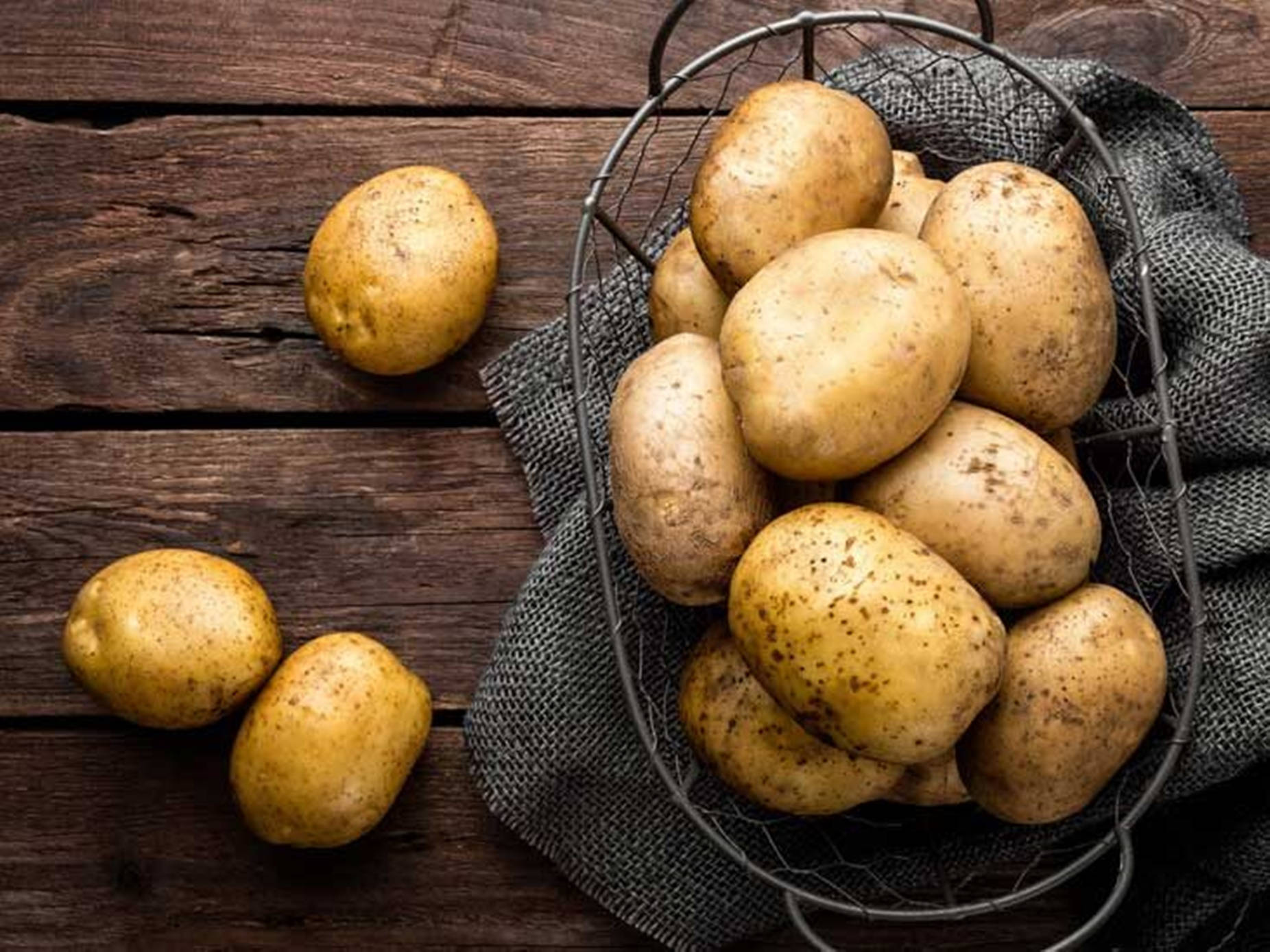 Potatoes On A Rustic Wire Basket Wallpaper