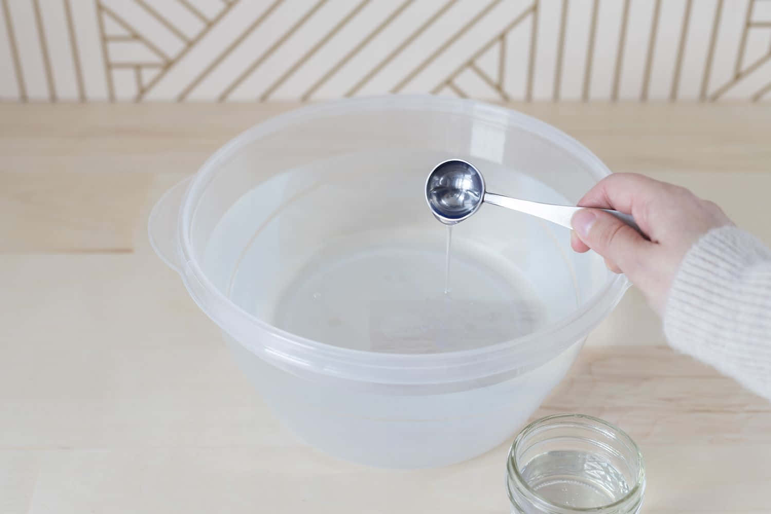Pouring Waterwith Spoon Over Bowl Wallpaper