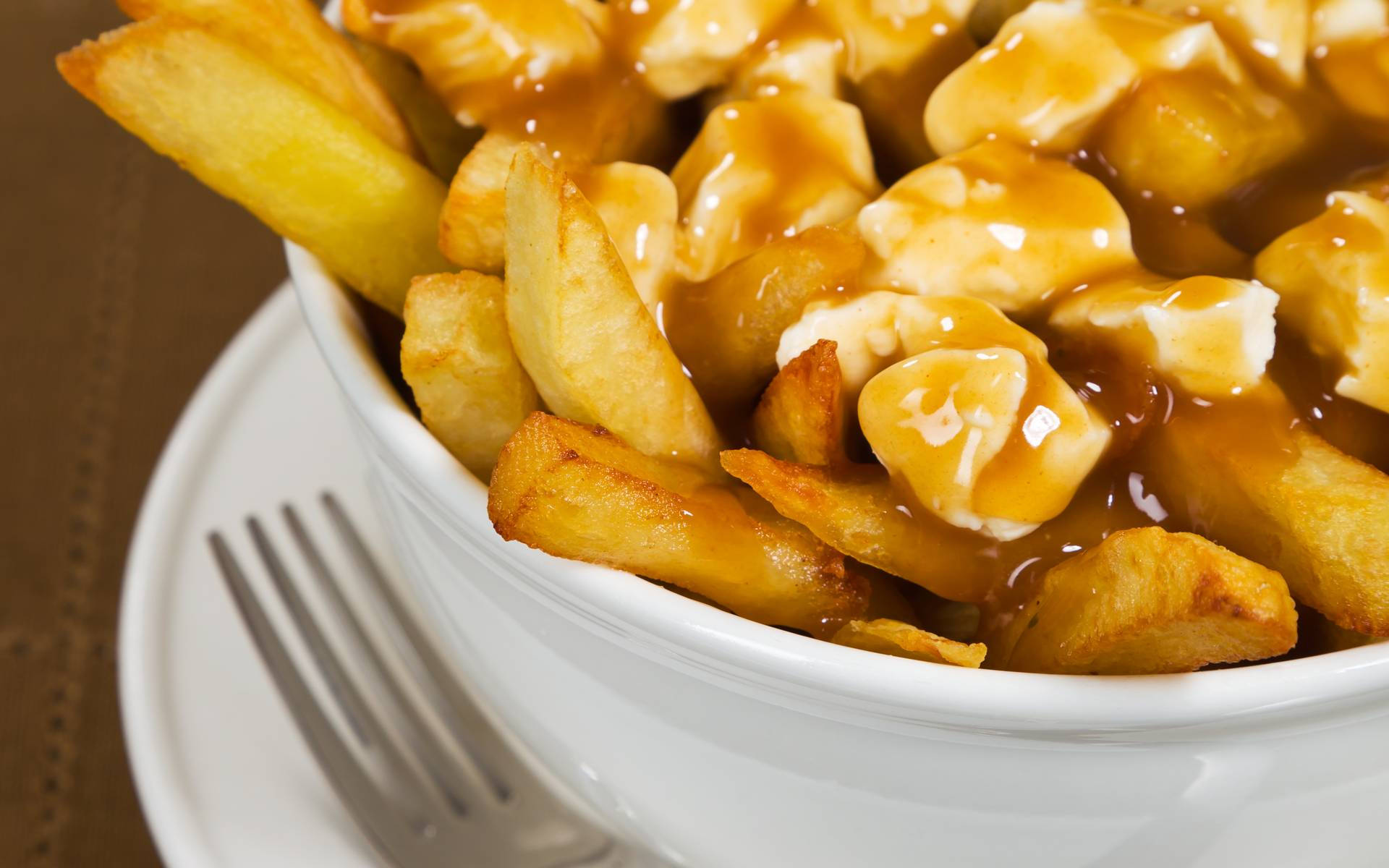 Delicious Poutine Dish in Close-Up View Wallpaper