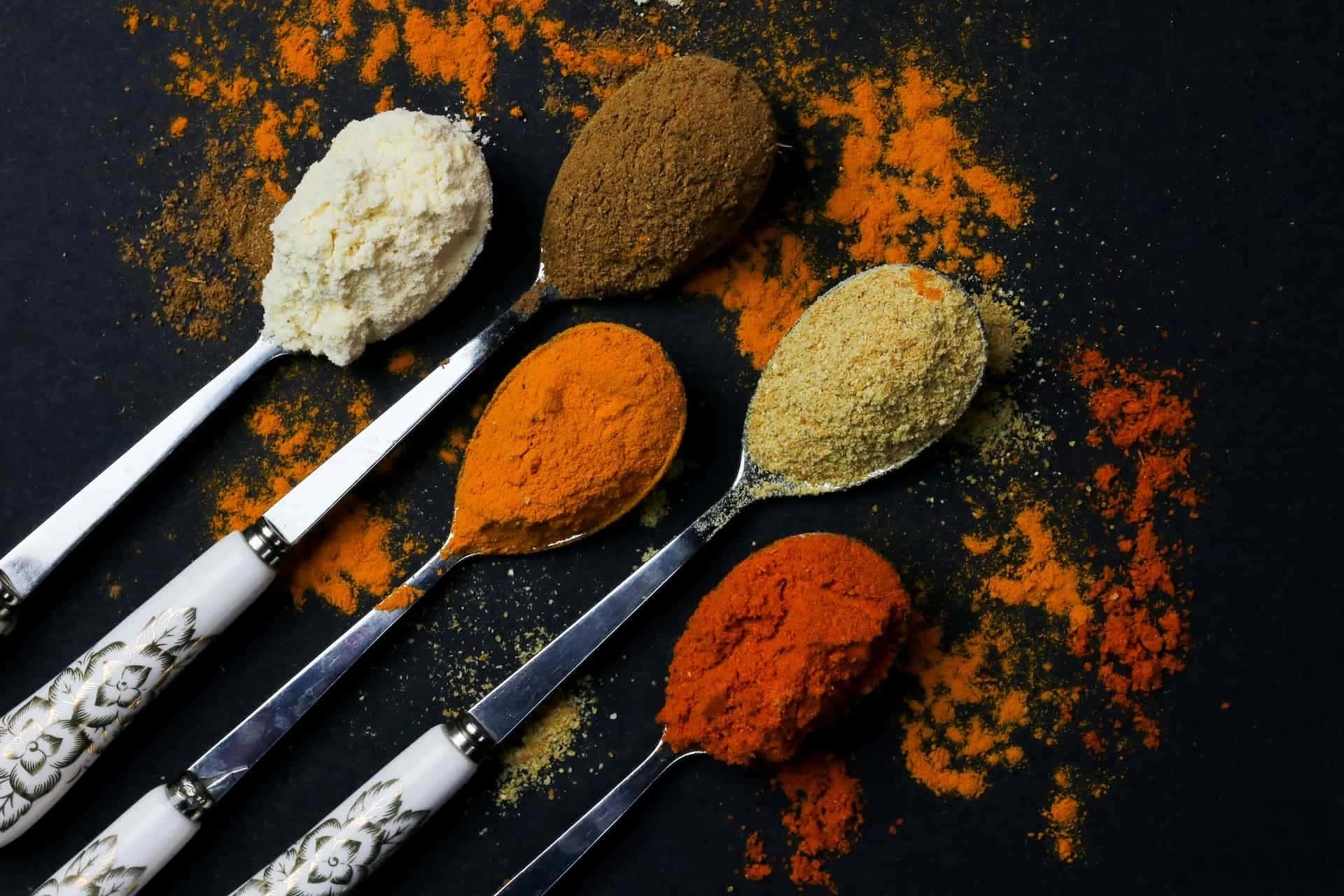 Powdered Spices On Silver Spoons Wallpaper