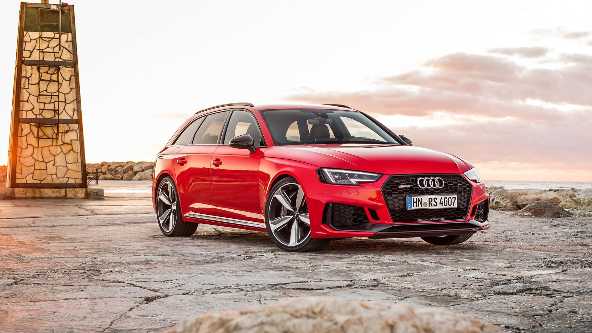 Power Meets Beauty - The Luxurious Audi Rs5 In A Dramatic Evening Setting. Wallpaper