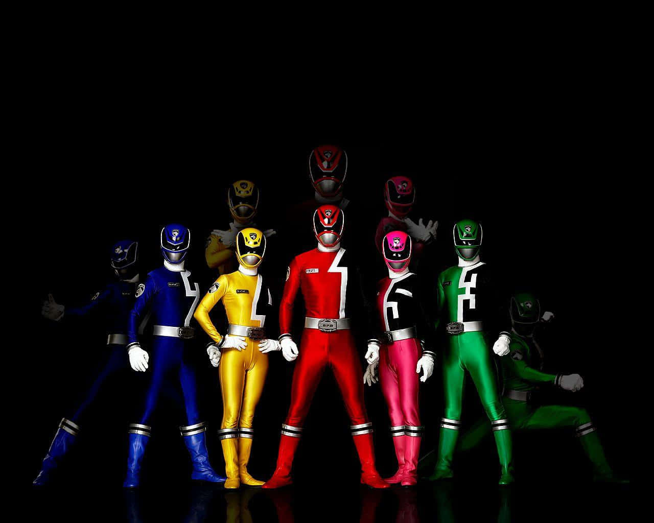 A Group Of Power Rangers Standing In Front Of A Black Background