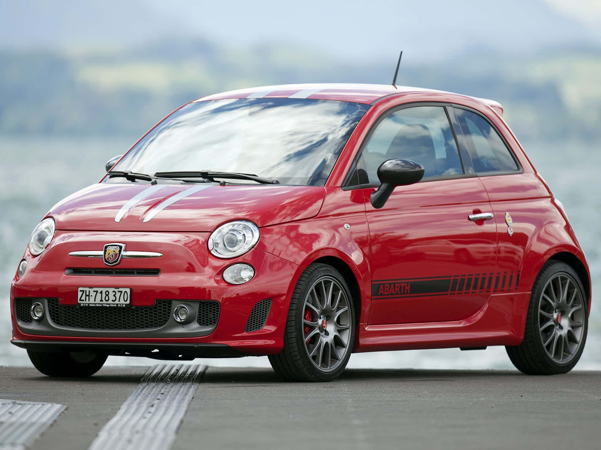 Powerful Abarth 695 Racing On The Road Wallpaper