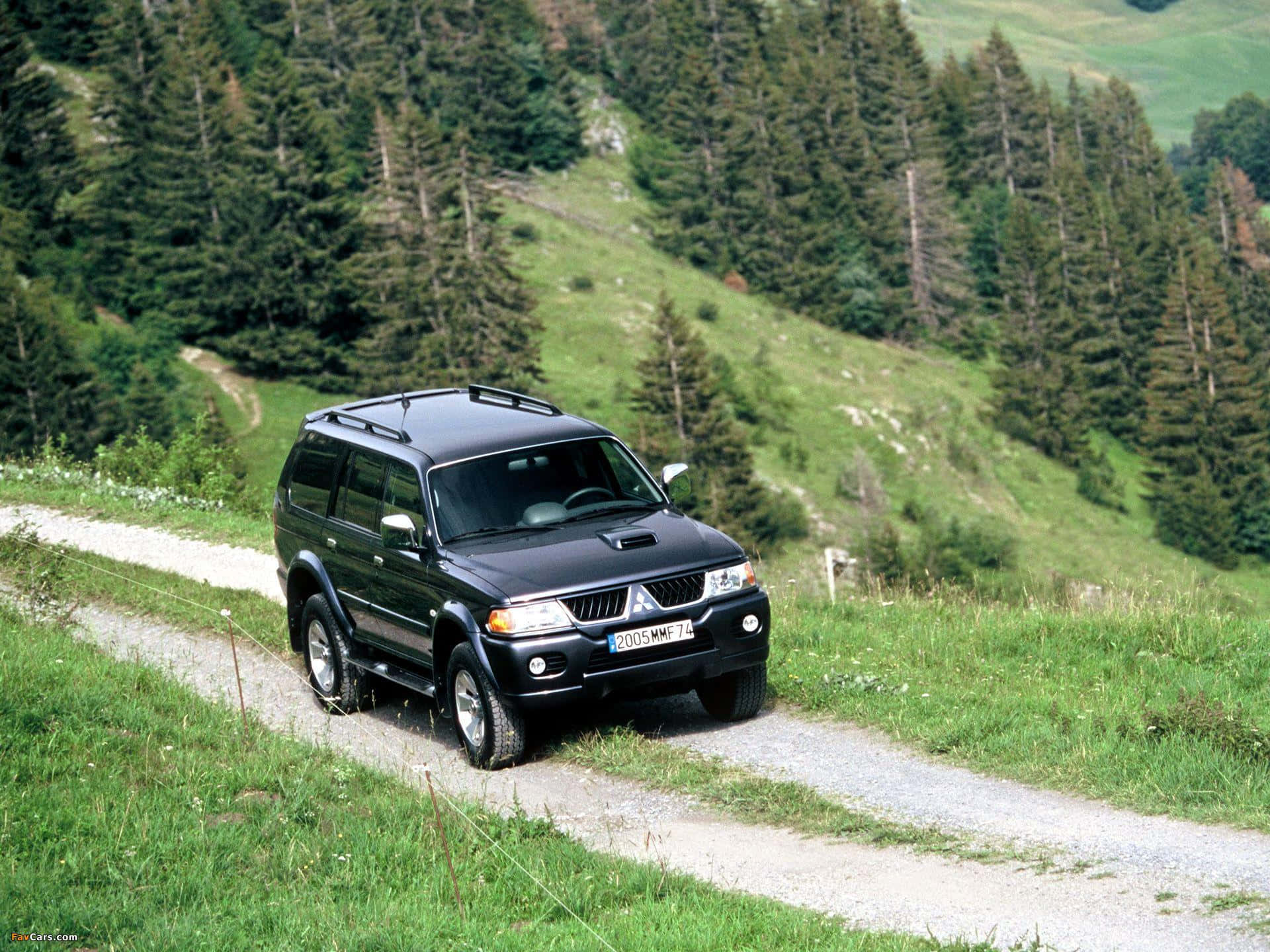 Powerful Mitsubishi Pajero Against A Mountain Range Wallpaper