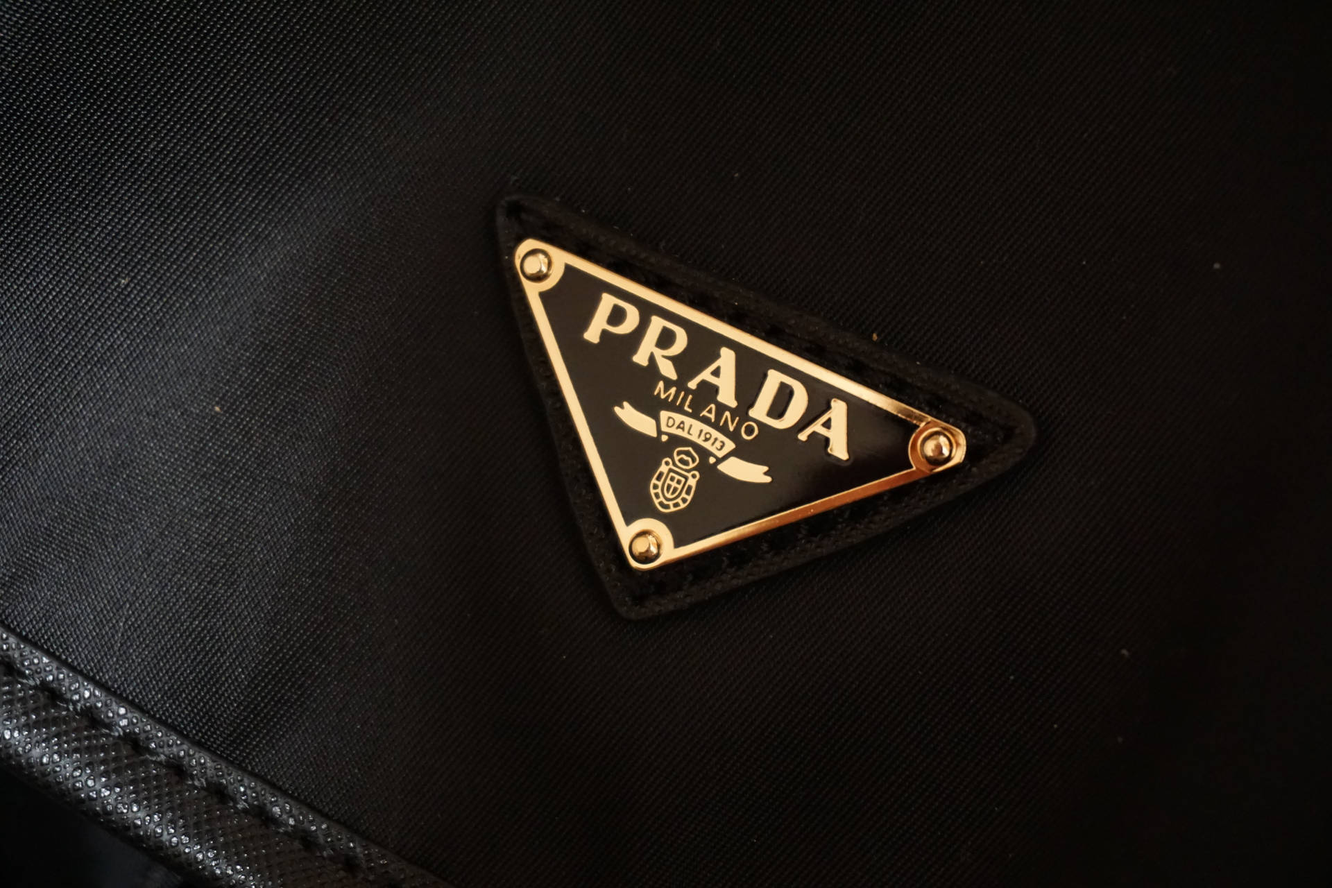 Prada Gold Badge