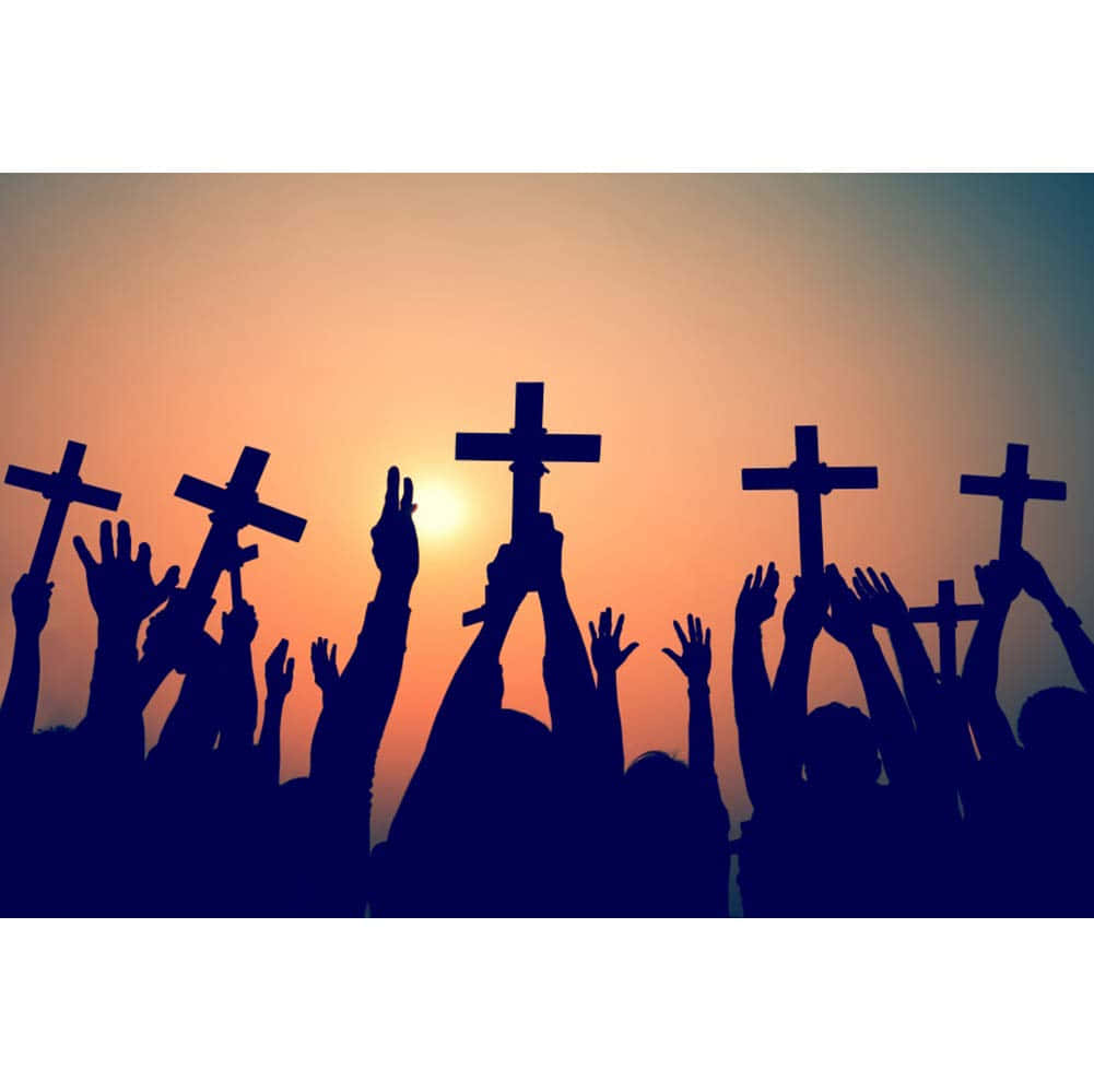 Silhouettes Of People Holding Crosses At Sunset