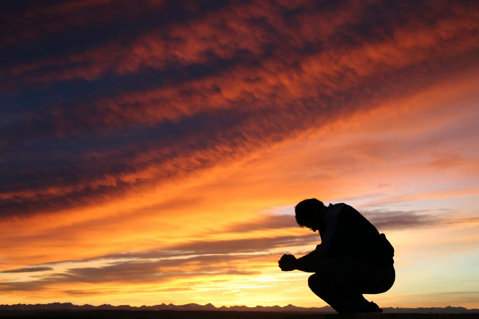 Man passionately praying at sunrise