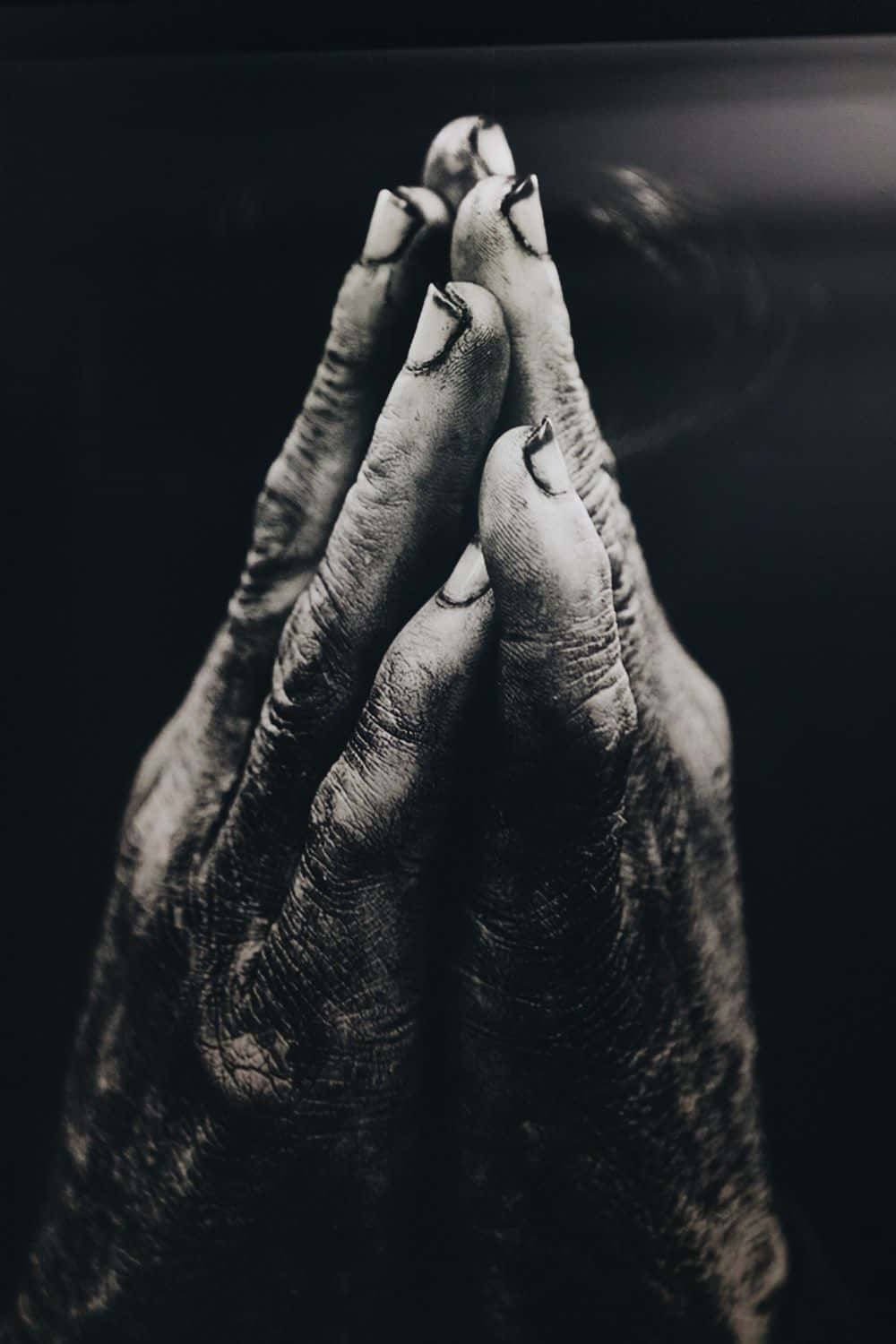A Black And White Photo Of A Hand Praying Wallpaper