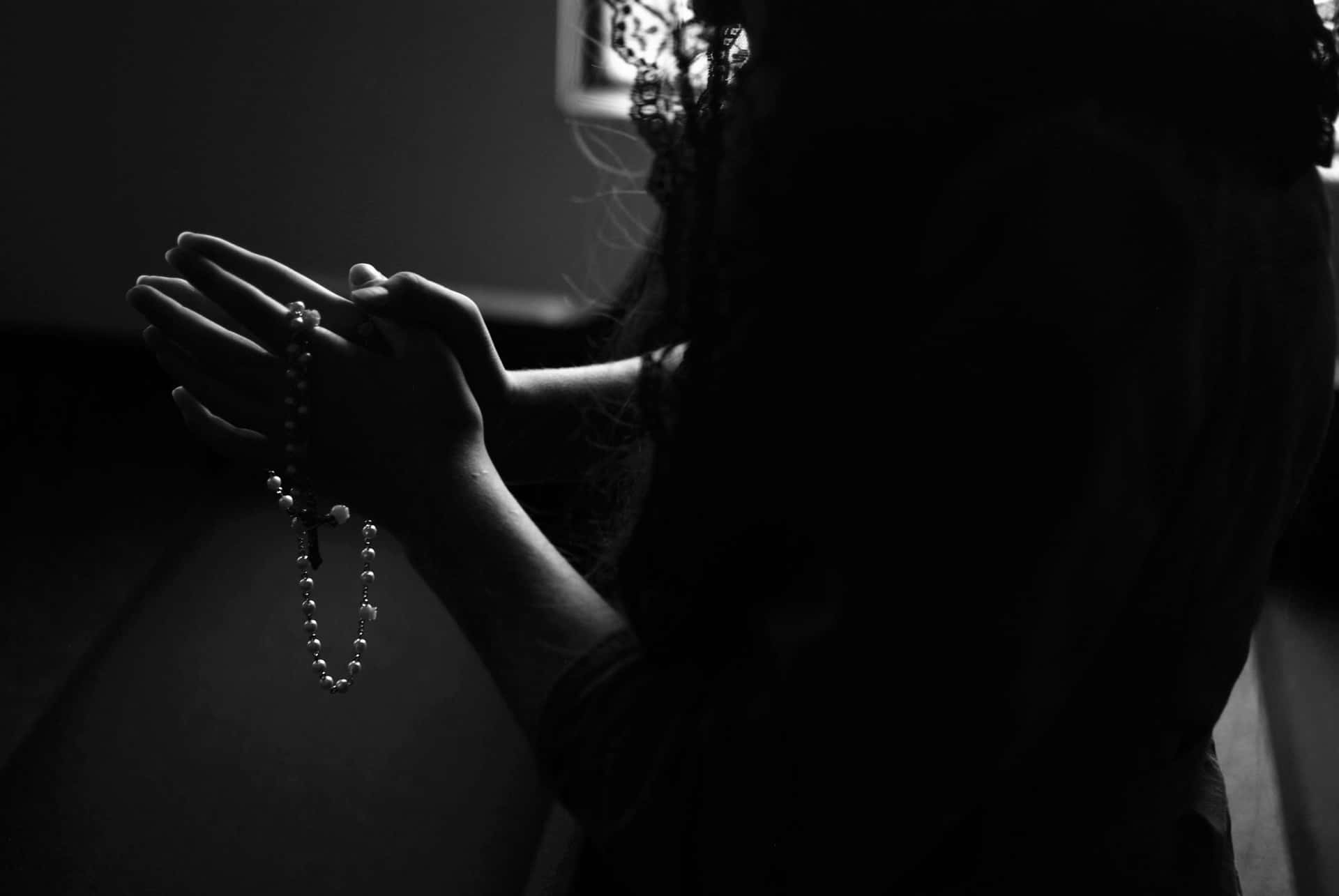Silhouetted Person With Praying Hands Picture
