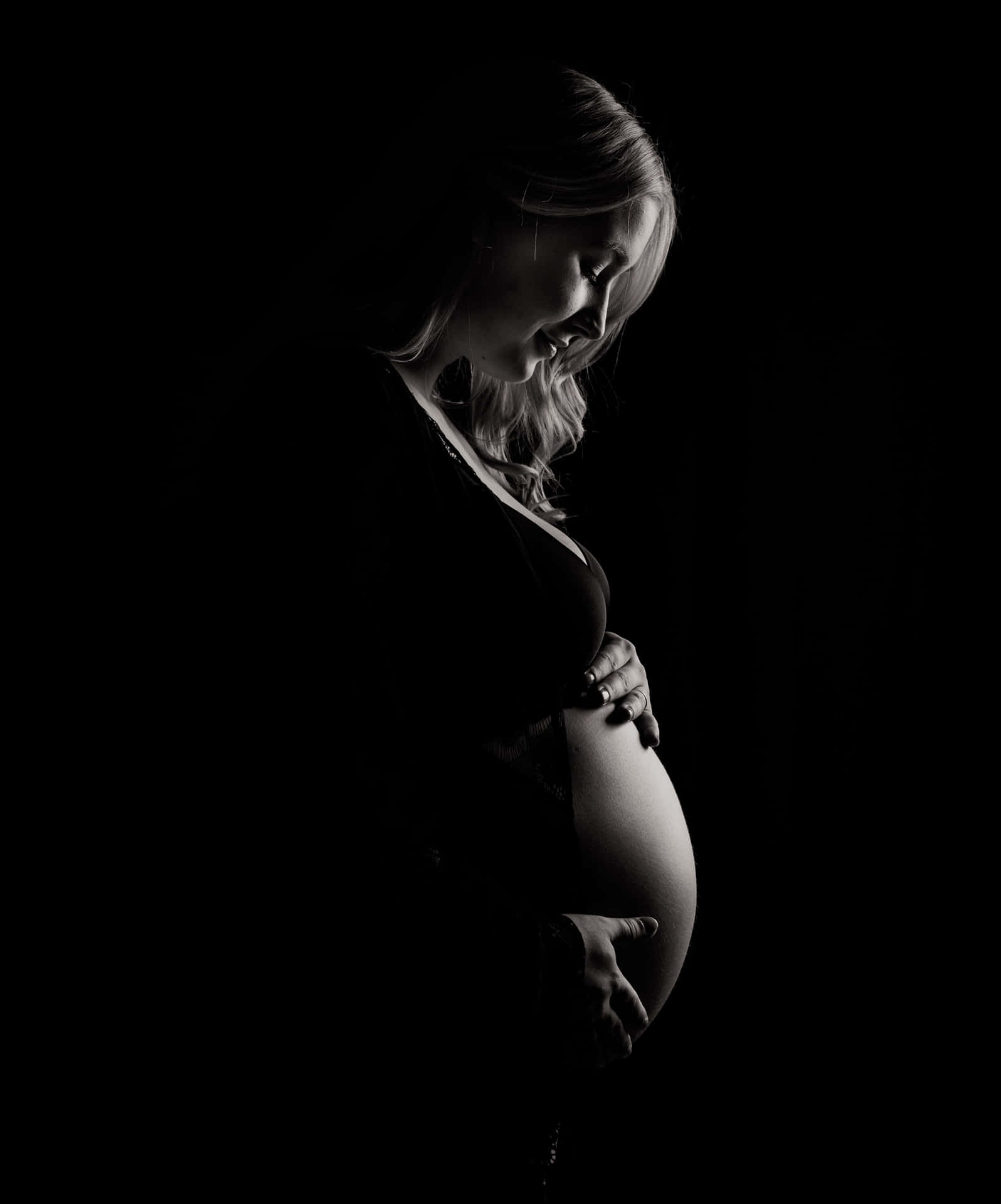 Beautiful pregnant woman standing in a serene environment
