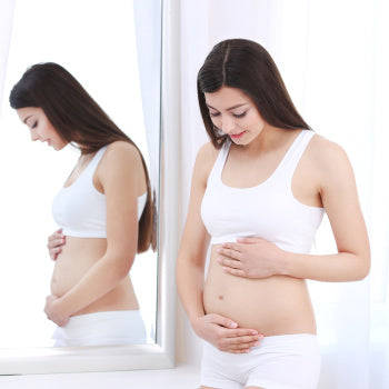 Pregnant Belly Next To Mirror Wallpaper
