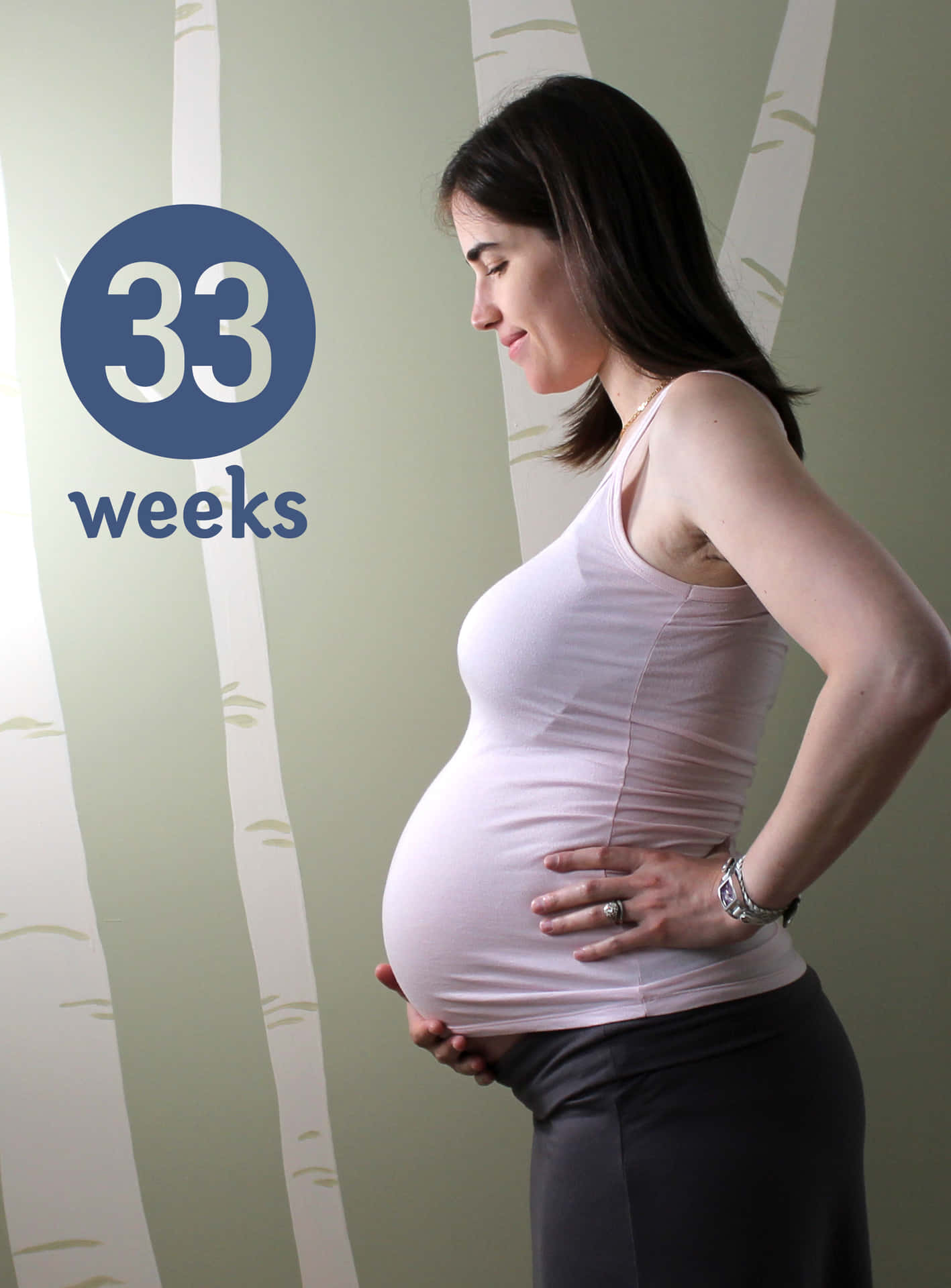 A woman in her third trimester of pregnancy, feeling the joy of new life.