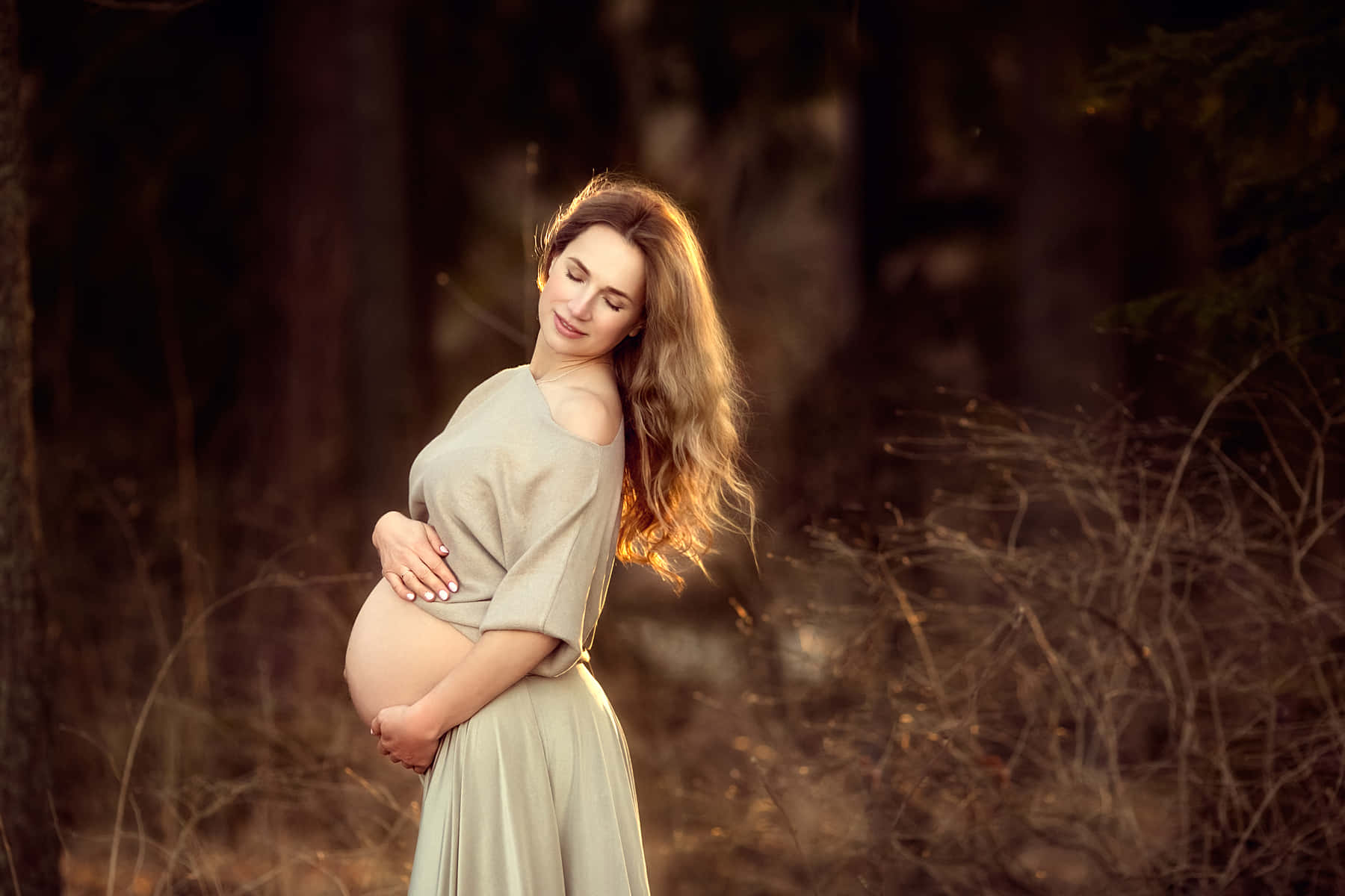 Radiant Expecting Mother with Baby Bump Wallpaper
