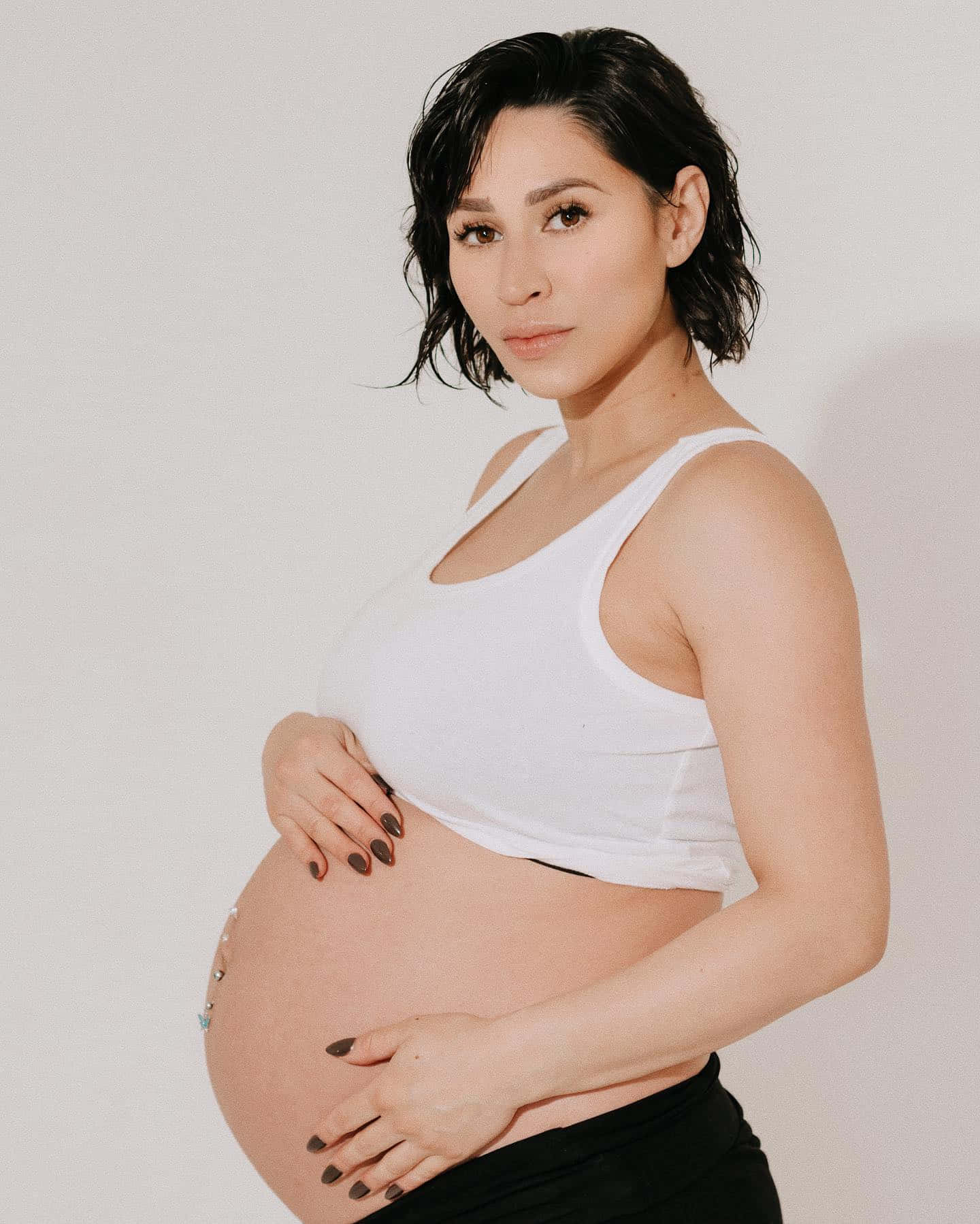 Pregnant Woman Posingin White Tank Top Wallpaper