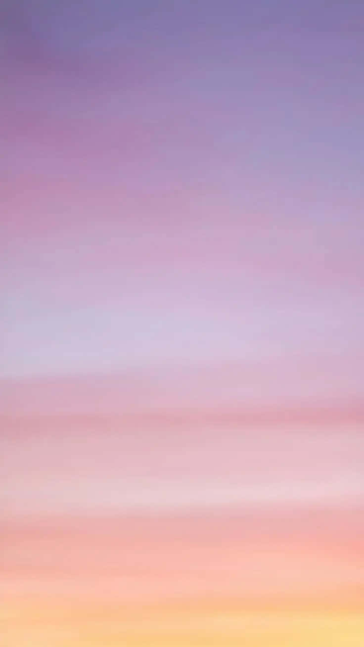 A Sunset With A Pink And Purple Sky