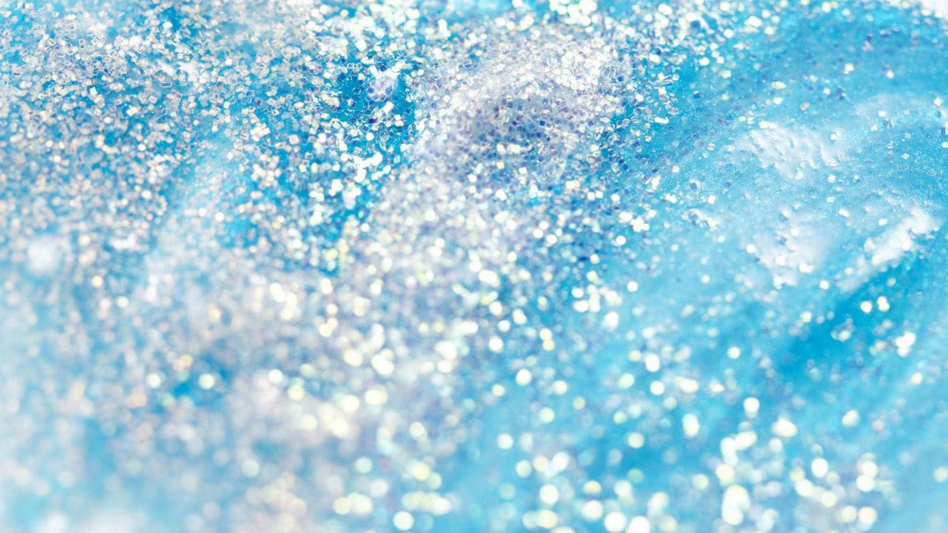 A Close Up Of A Blue And Silver Liquid Wallpaper