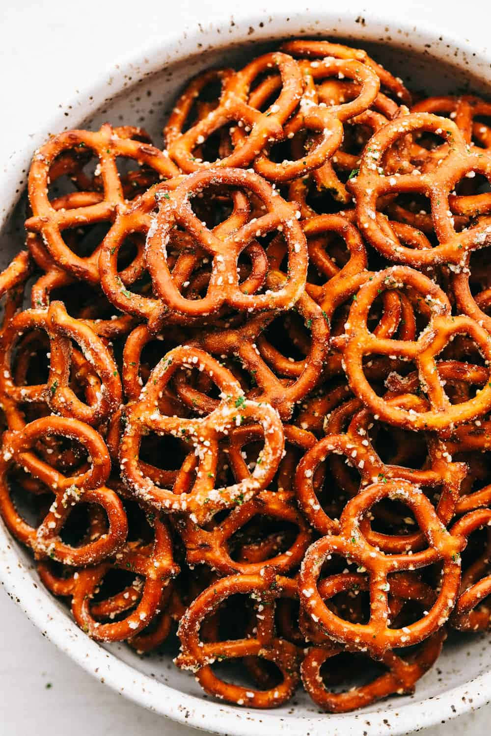 A Bowl Of Pretzels With Salt And Pepper