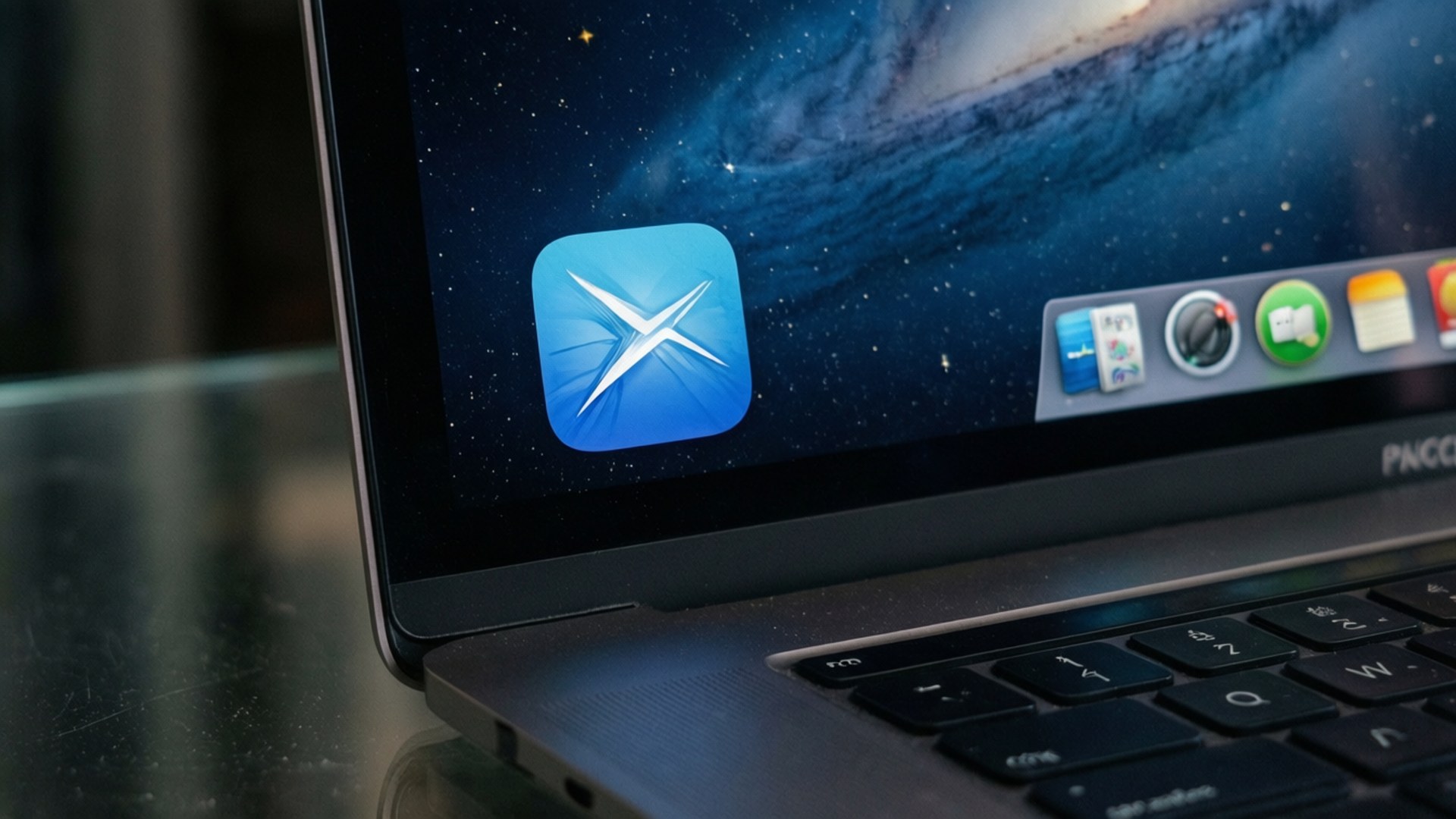 A realistic close-up of the Preview app icon on a MacBook with a starry night background.