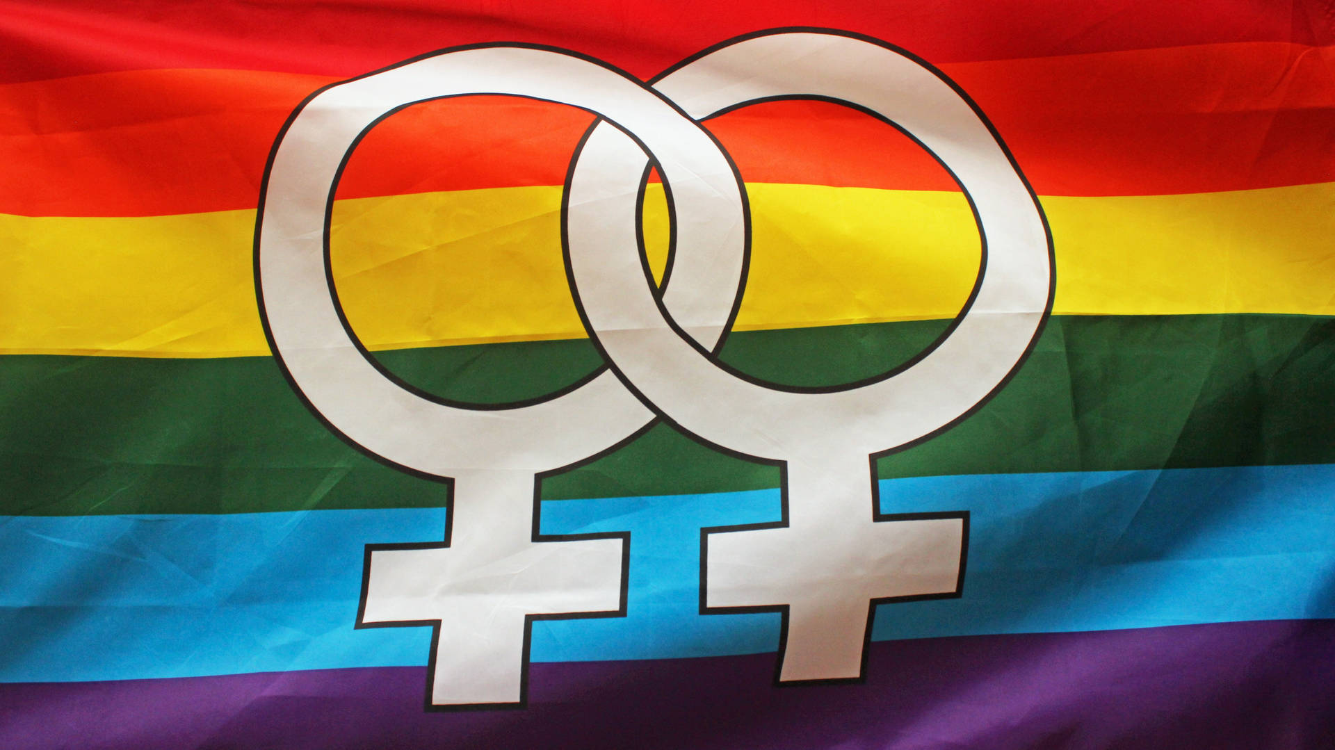 Caption: Vibrant Display of the Pride Flag Symbolizing Lesbian Unity Wallpaper